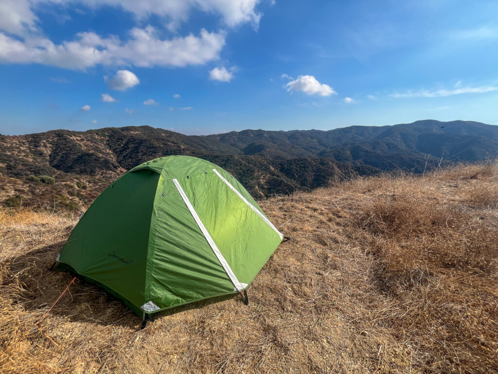 Clostnature Polaris 2 with a fully zipped up rainfly and mountains in the background