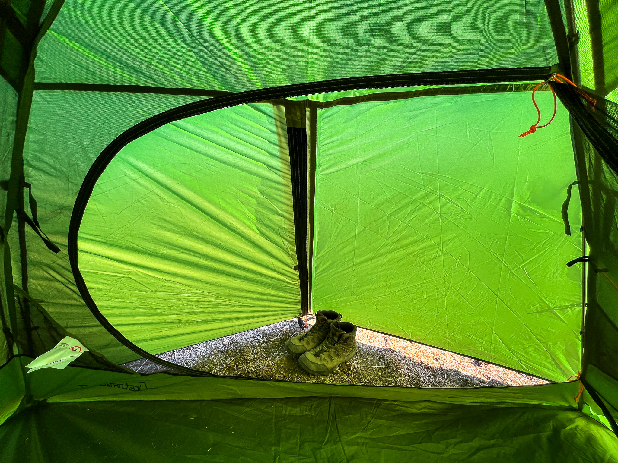 Interior view of the Clostnature Polaris 2 looking out into the fully enclosed vestibule area with a pair of hiking boots.