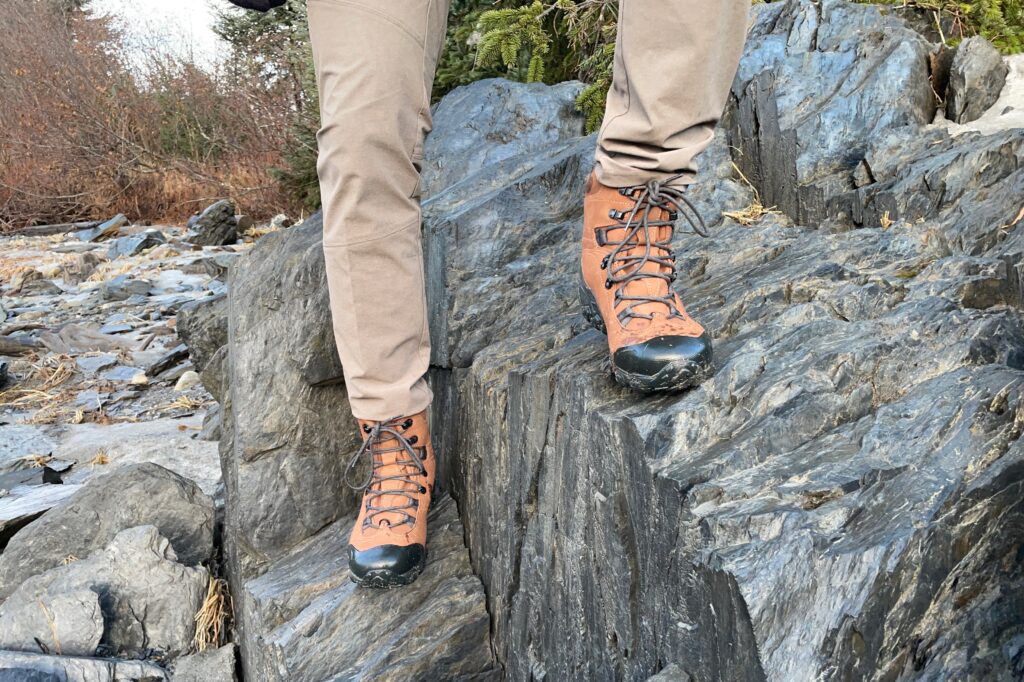 A closeup of winter boots on a rocky outcropping