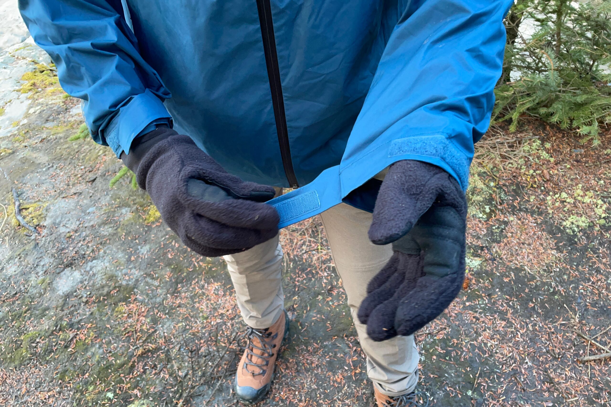 A man tightens the cuffs of his jacket.