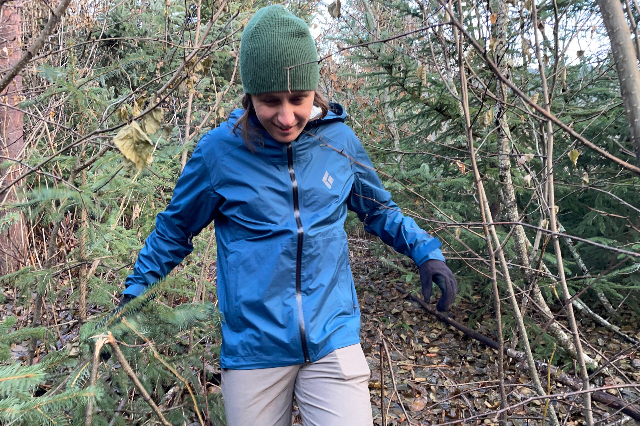 A man walks through thick brush.