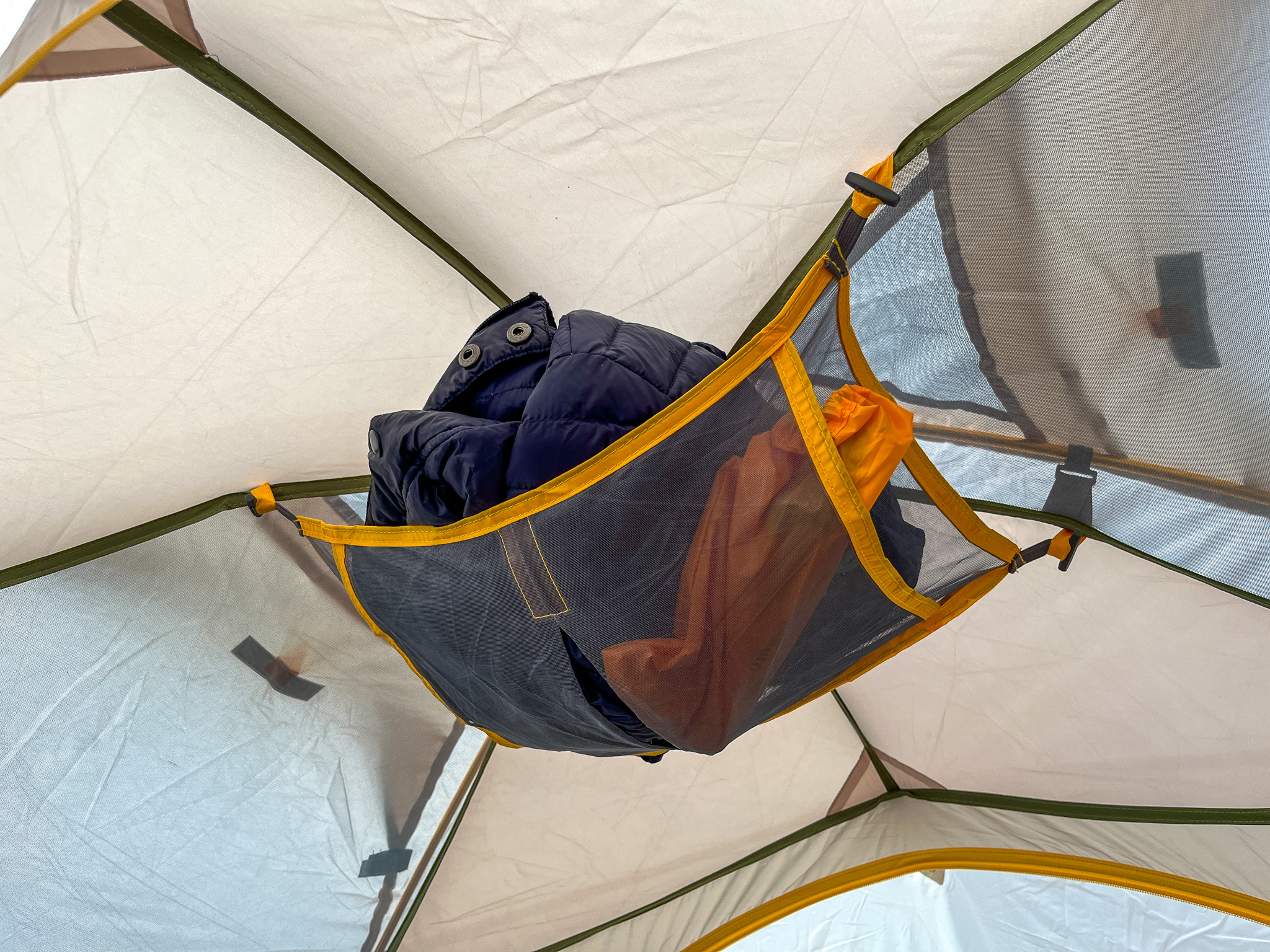 A close-up of the upper removable gear loft in the Mountainsmith Morrison EVO 2. Showing a jacket and other small items stowed away.