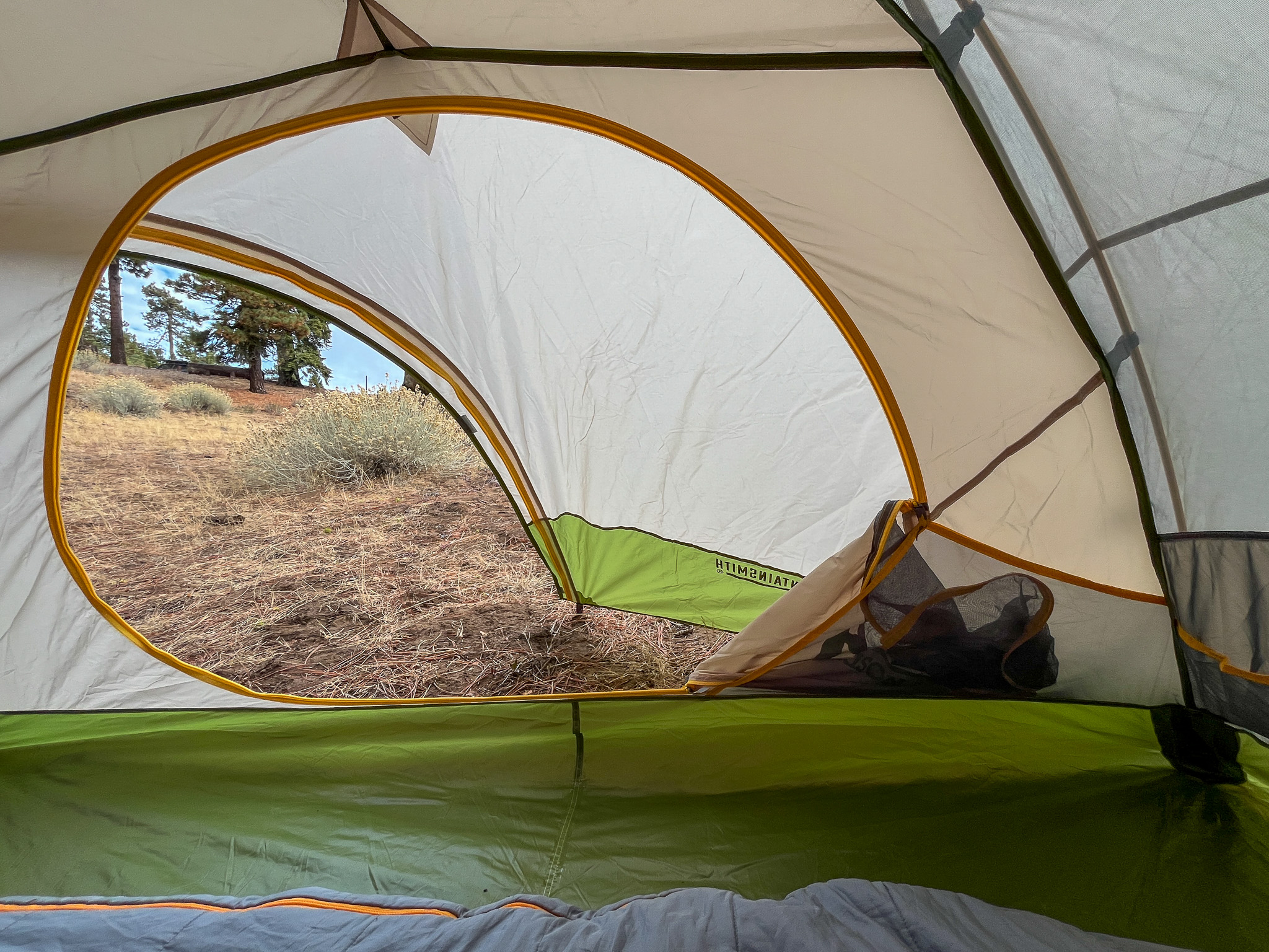 A view from inside the Mountainsmith Morrison EVO 2. It faces out the oversized door and vestibule, showcasing the spacious interior and door stow pockets.