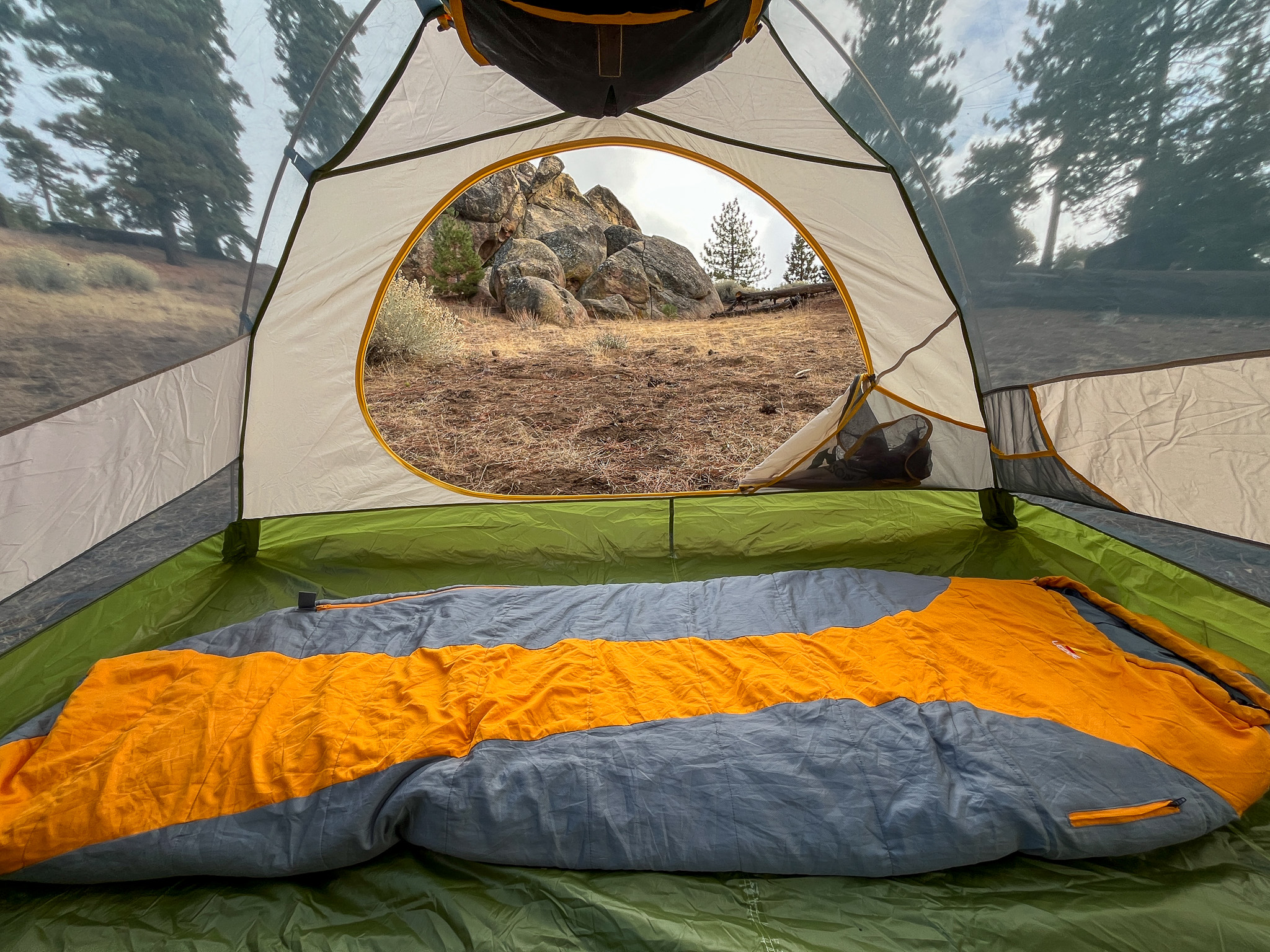 A view of the interior of Mountainsmith Morrison EVO 2 interior with a sleeping bag, showcasing its spaciousness and scenic views.