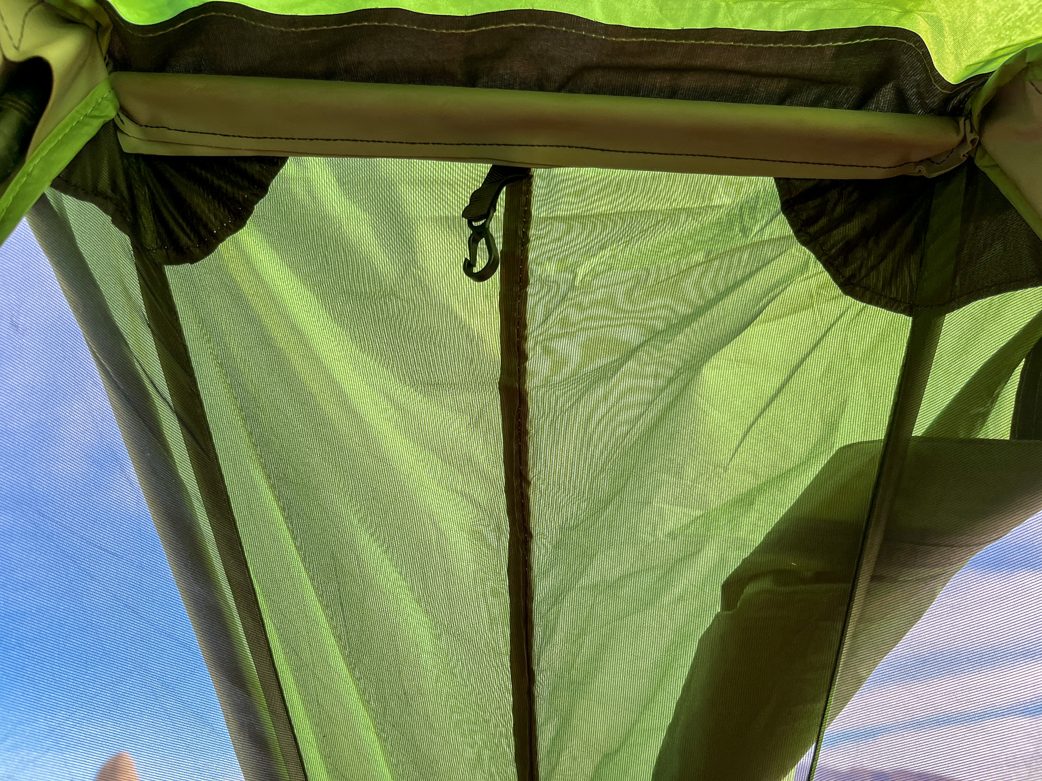 Closeup shot of the integrated ridge bar for added stability and support after staking the corners and pitching the poles.