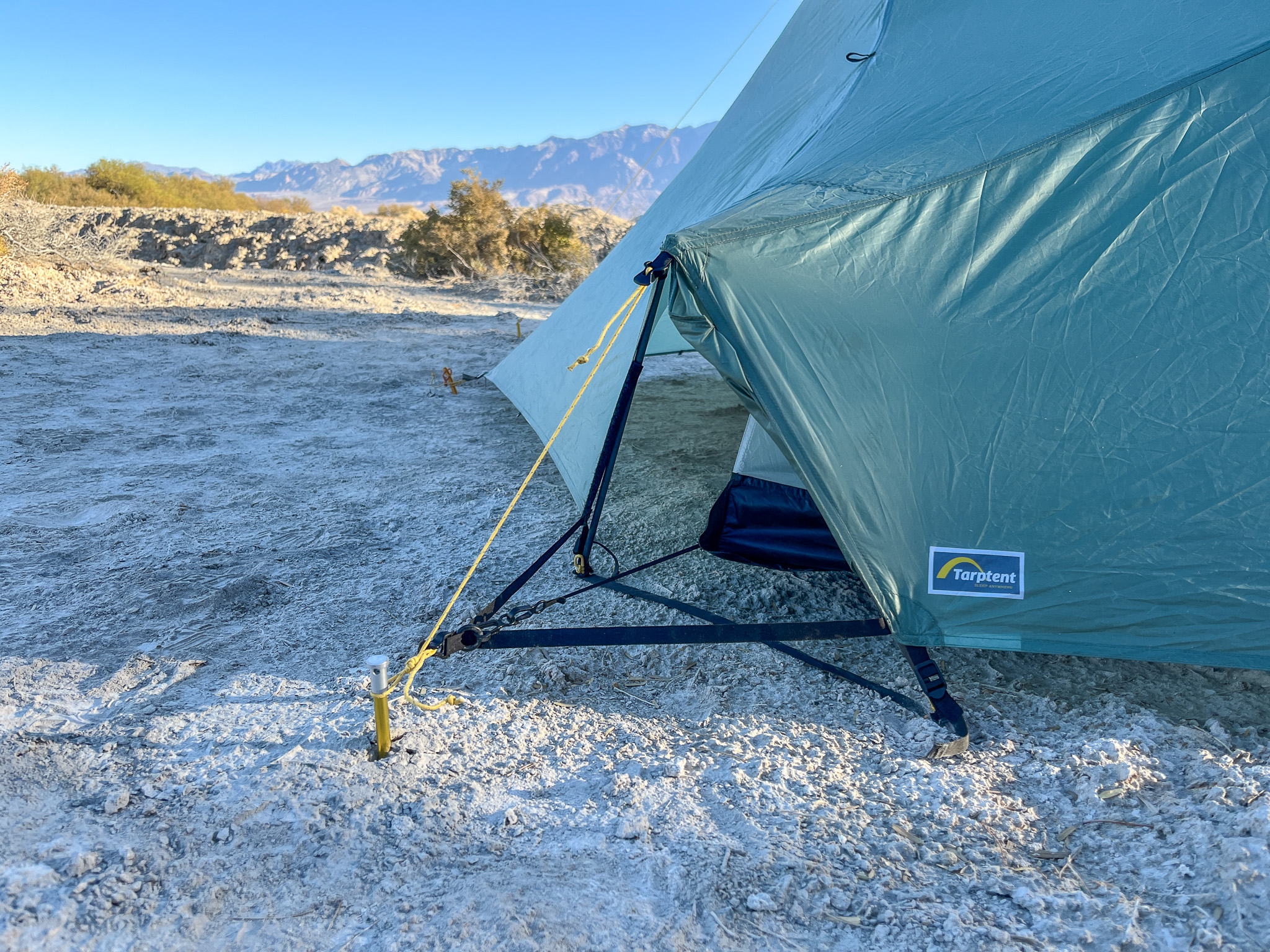 Closeup view of the pitch-lock vents open and all of its structural components. Desert bushes and mountains in the background.