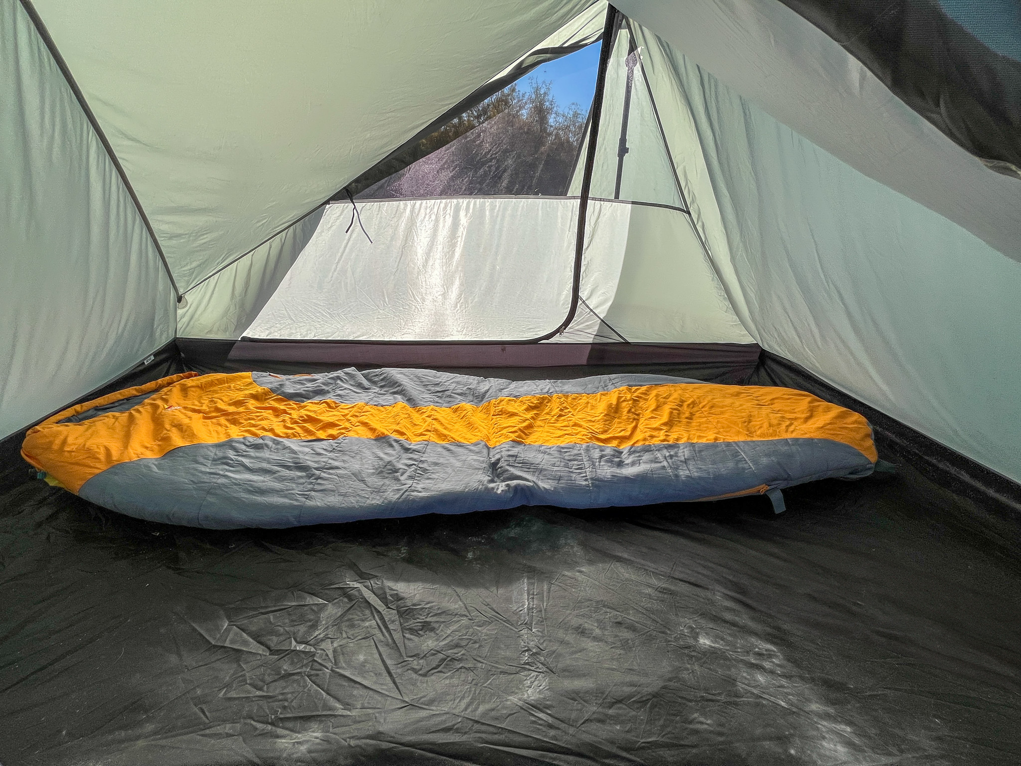 Inside view of the Tarptent Stratospire 2 with the solid fabric inner tent showing the interior room and floor space with one sleeping bag inside