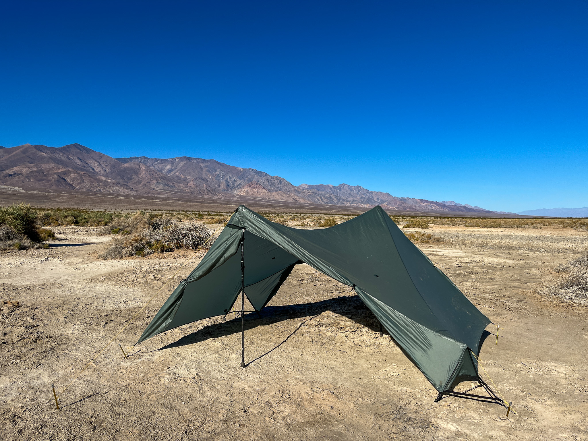 The Tarptent Stratospire 2 pitched with the rainfly only, showcasing minimalist mode or a quick shade shelter. Desert landscape and mountains in the background.