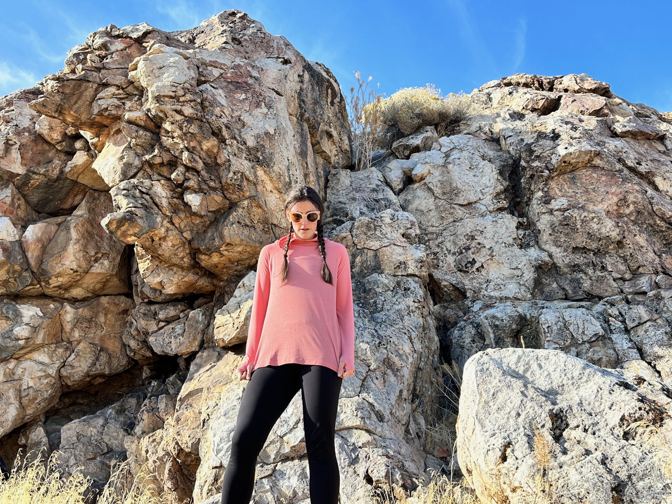 woman hiking with day pack in rocky high desert landscape