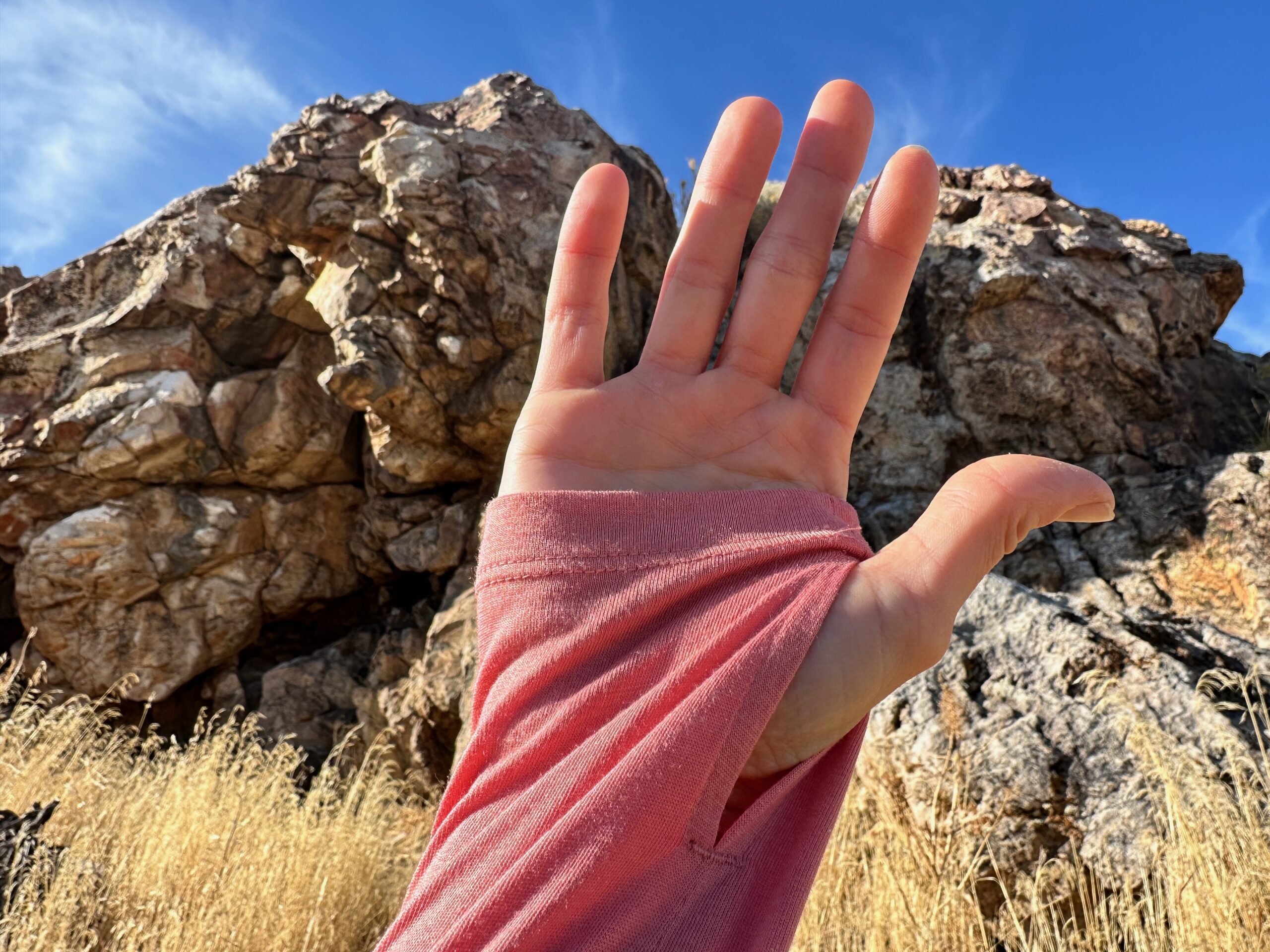 woman hiking with day pack in rocky high desert landscape