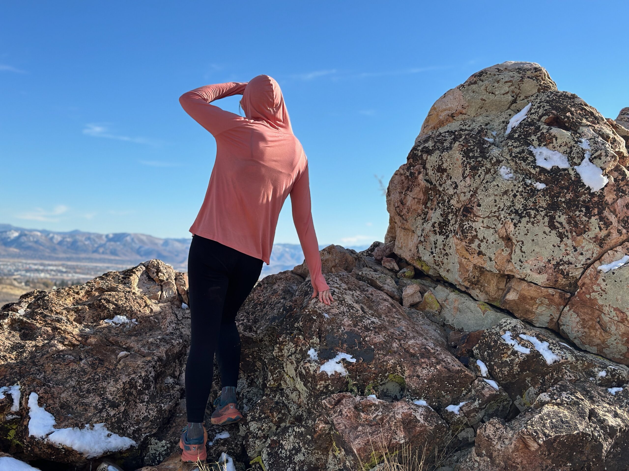 woman hiking with day pack in rocky high desert landscape