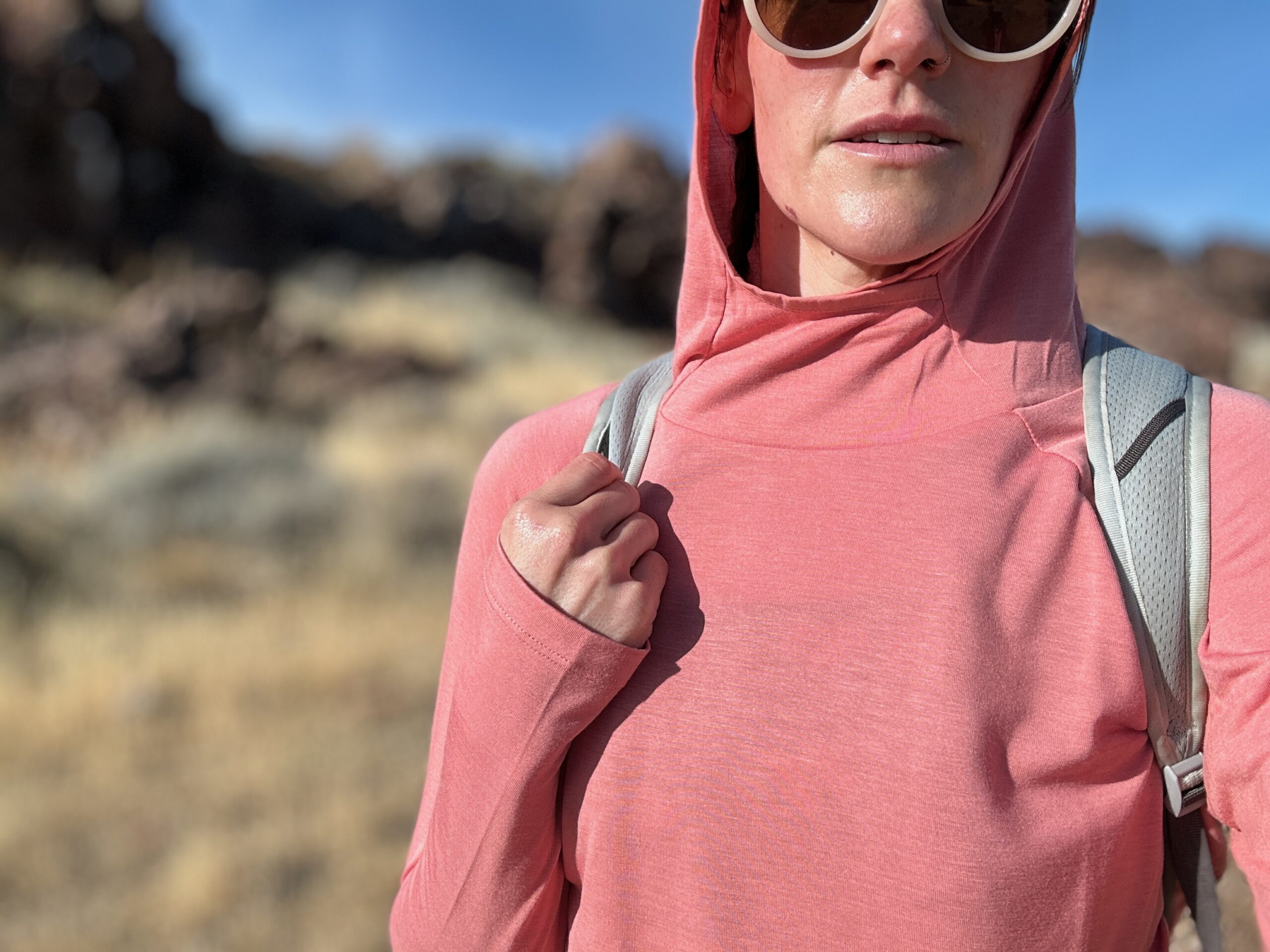 woman hiking with day pack in rocky high desert landscape