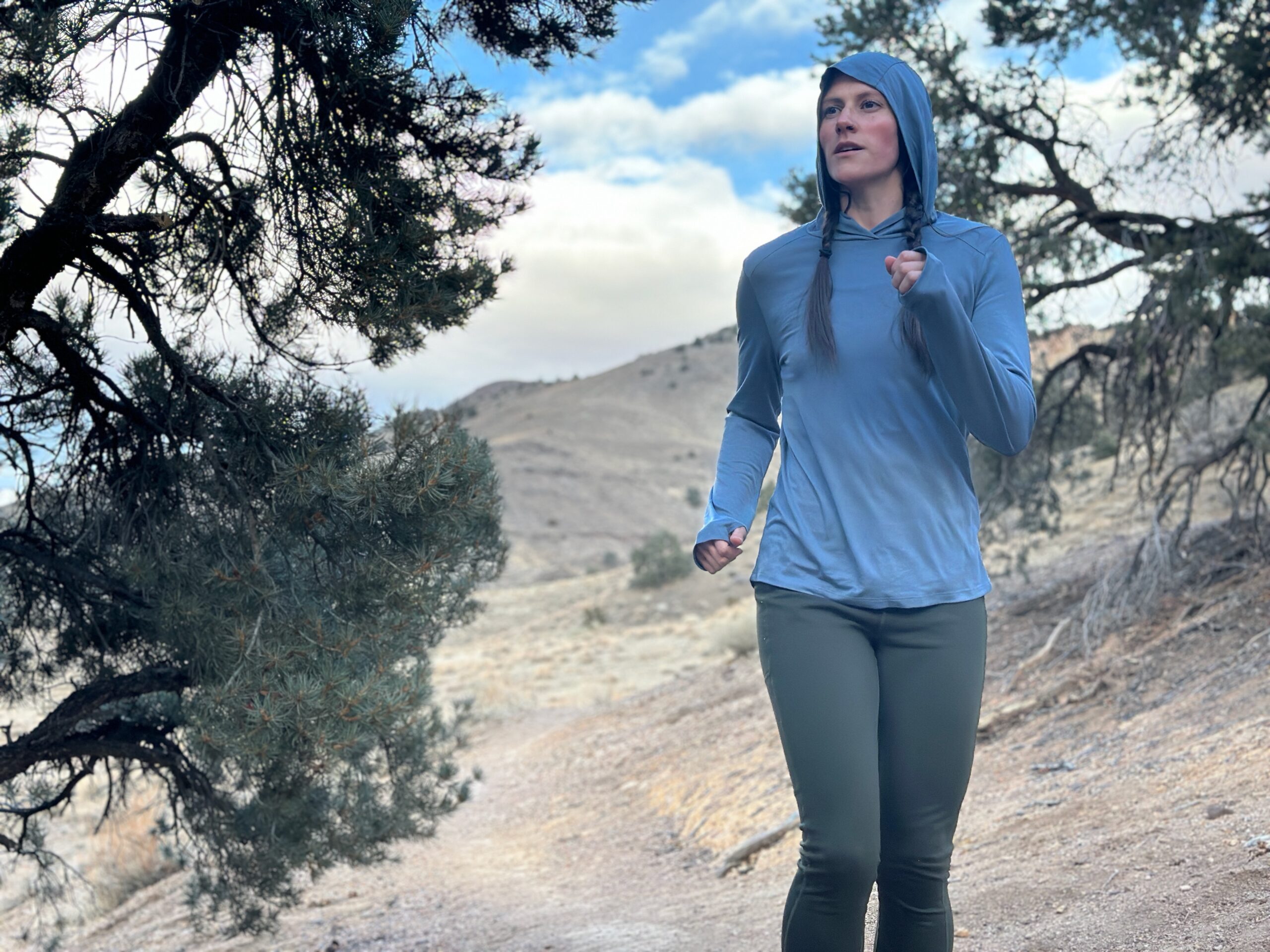 Woman hiking in high desert with backpacking pack on