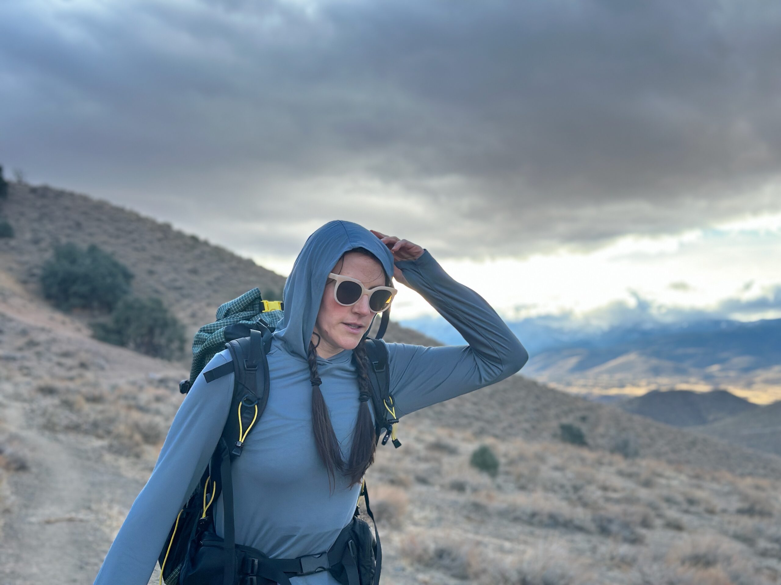 Woman hiking in high desert with backpacking pack on