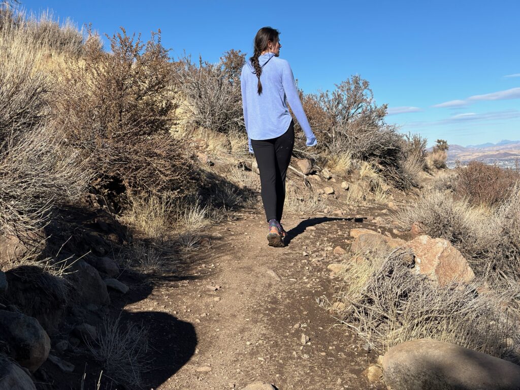 woman hiking in high desert with dog