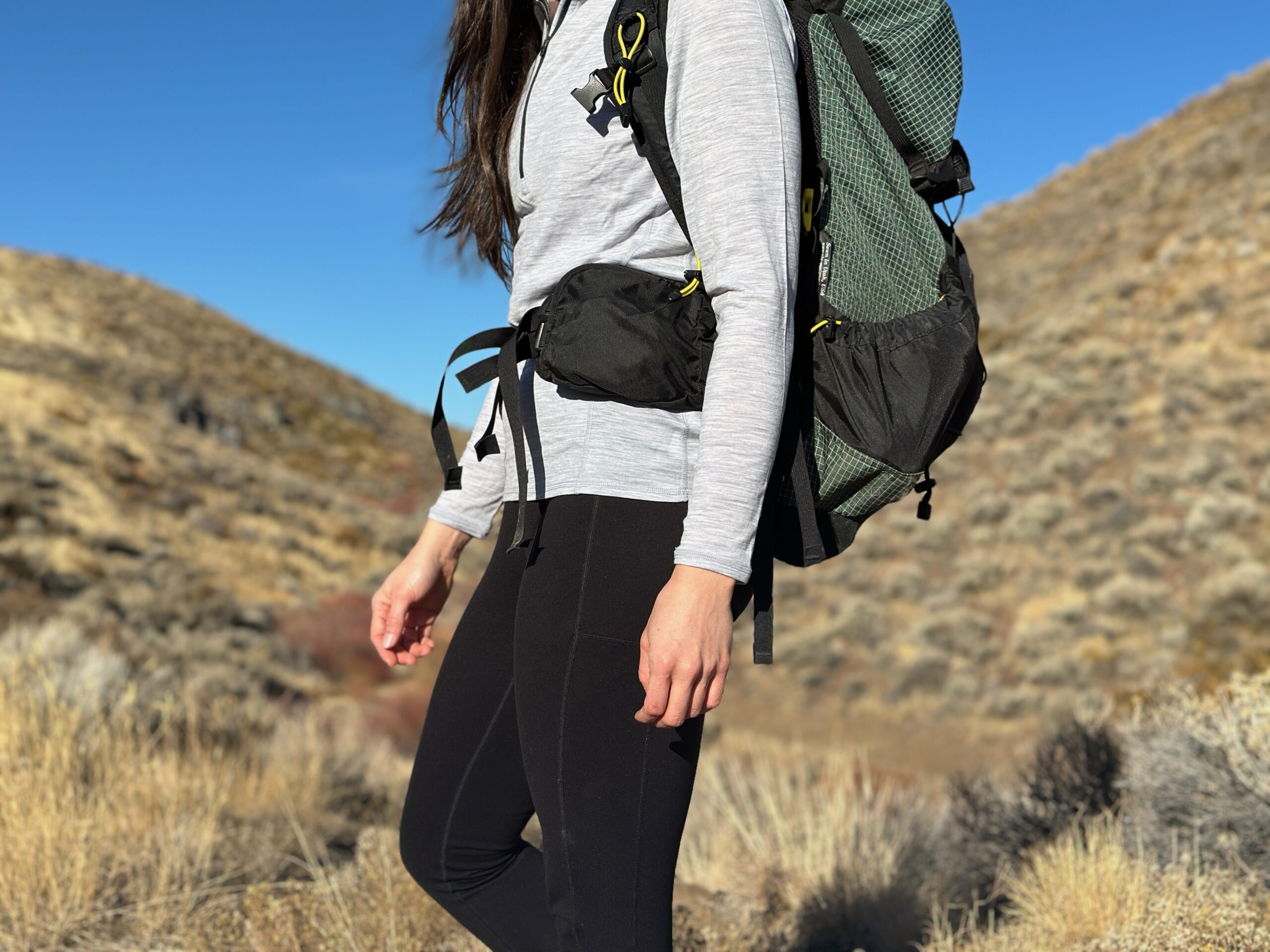 woman hiking with backpacking pack on through high desert