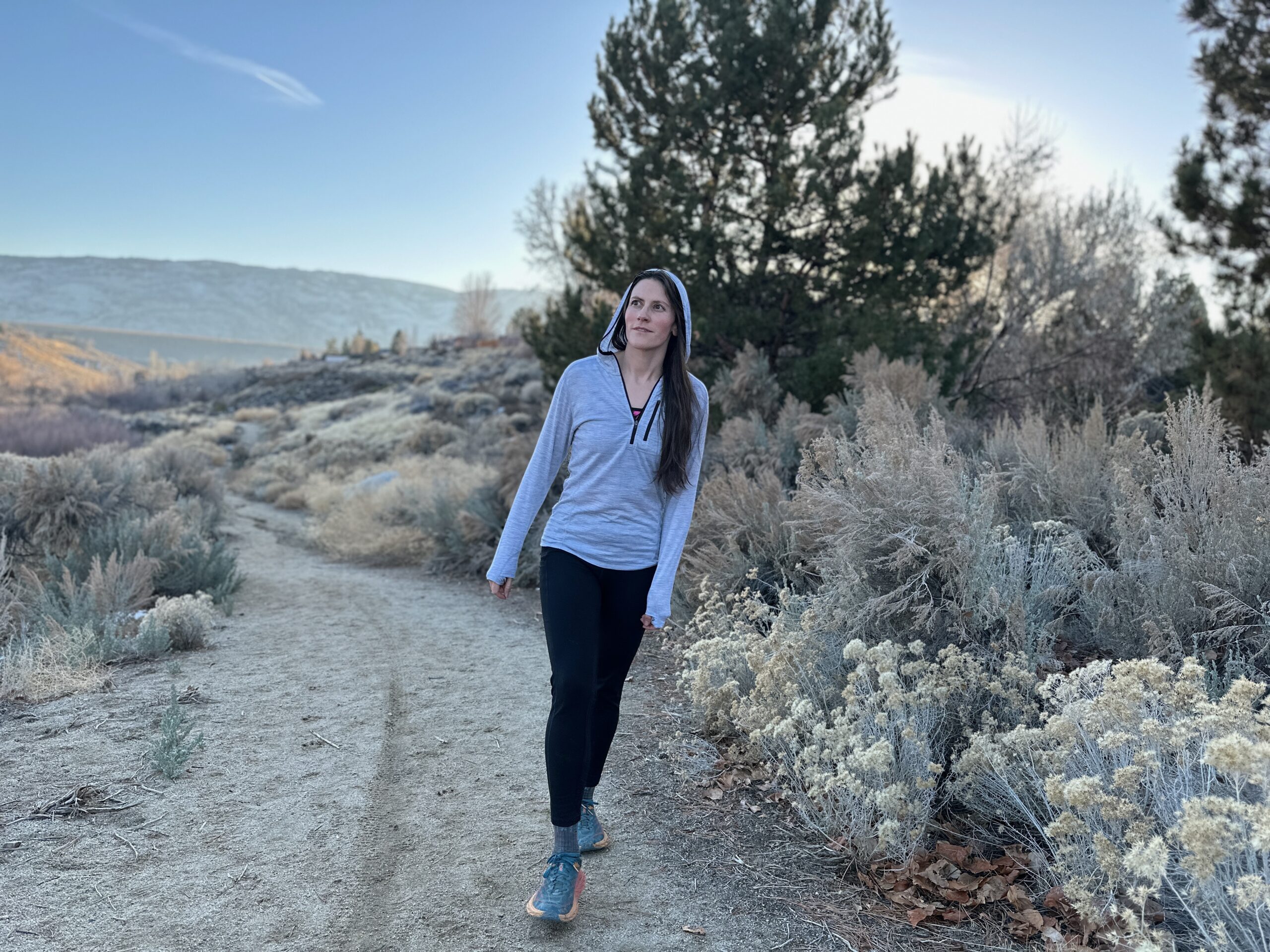 woman hiking around high desert plants 