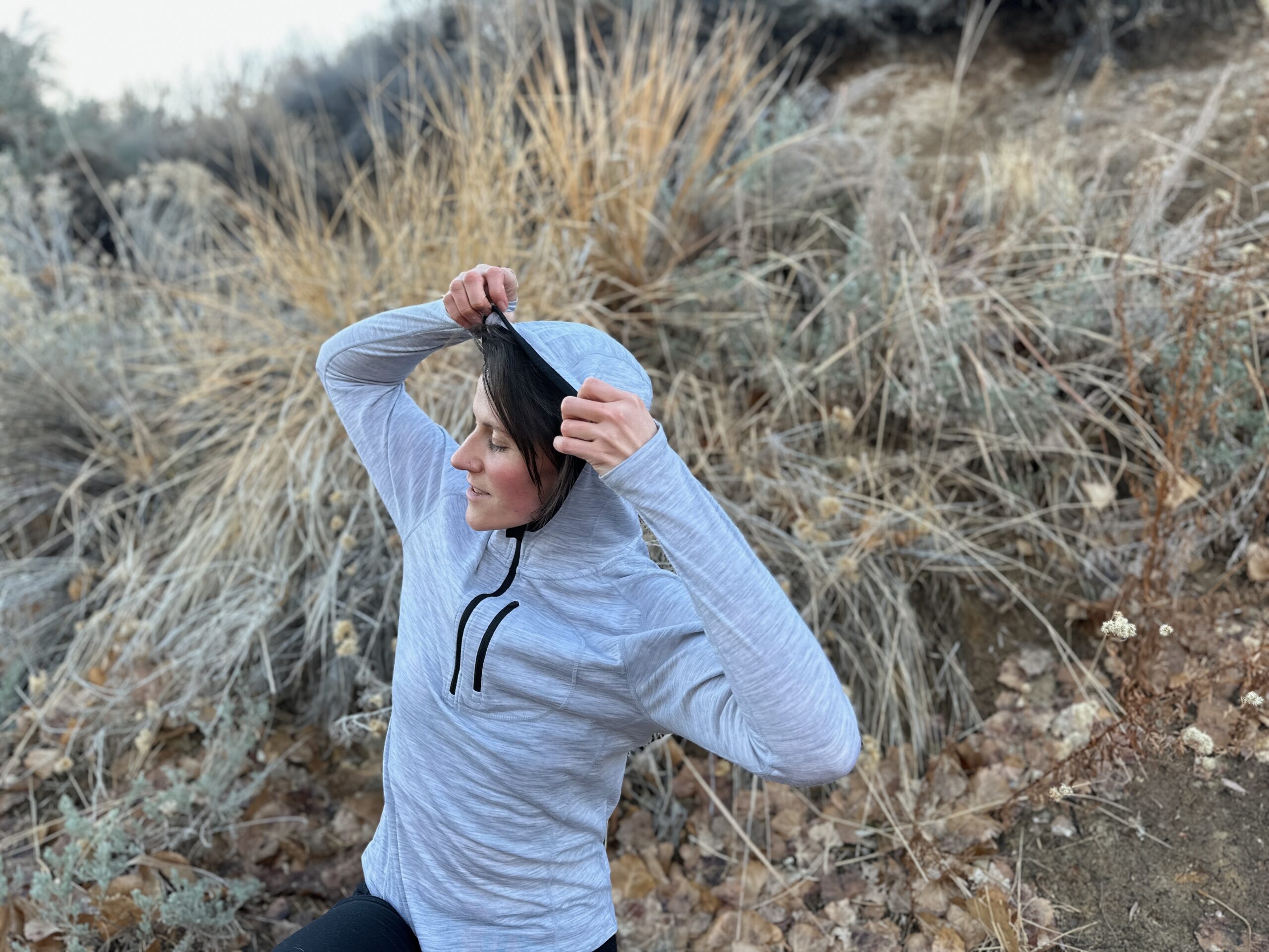 woman hiking around high desert plants 