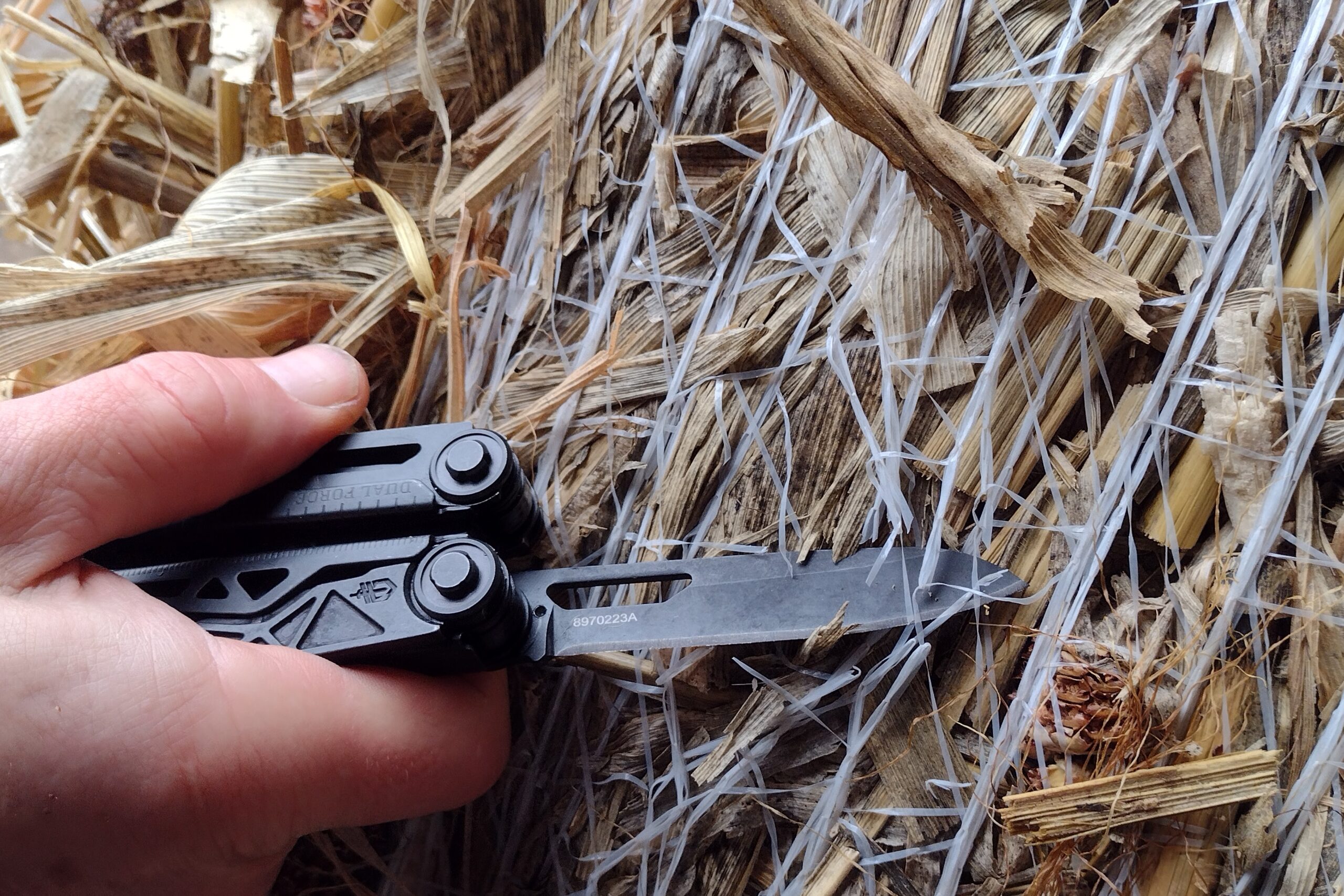 The Gerber Dual force cutting hay bale netting with its knife blade.