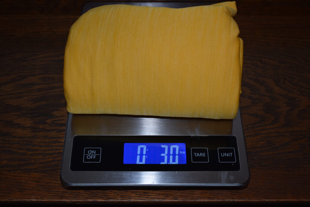 Fillo Elite Luxury Pillow on a kitchen scale that reads 3 ounces