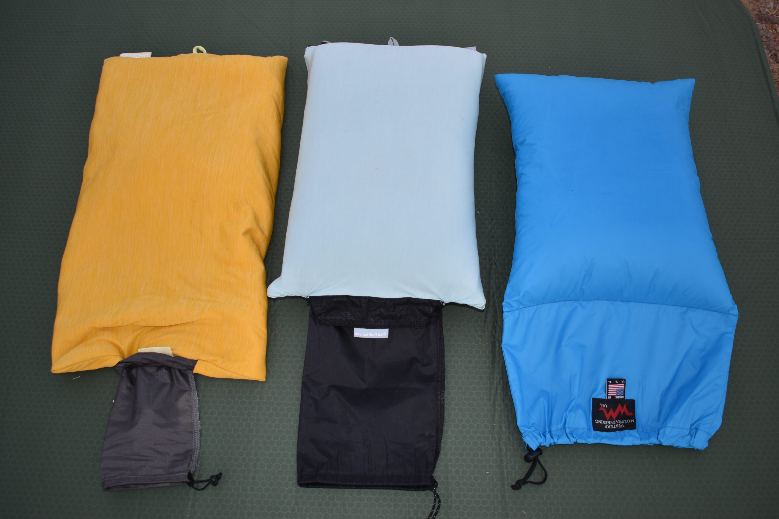 three camping pillows next to each other to show their size and packability into smaller stuff sacks