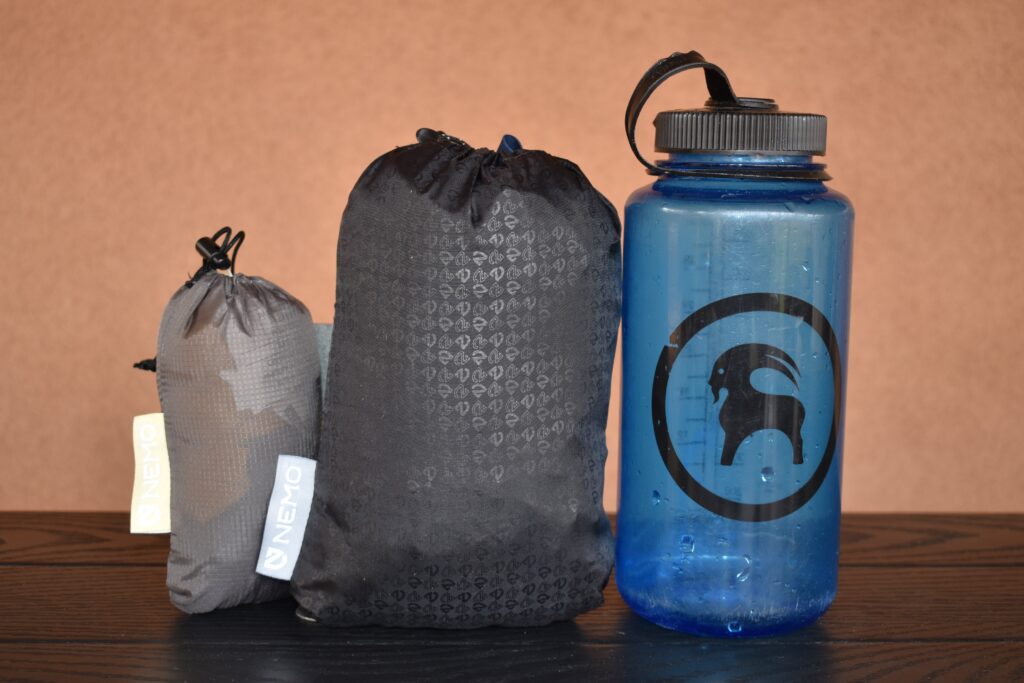 From left to right, the packed NEMO Fillo Elite Luxury pillow (smallest), NEMO Fillo pillow (much larger), and a Nalgene bottle (largest)