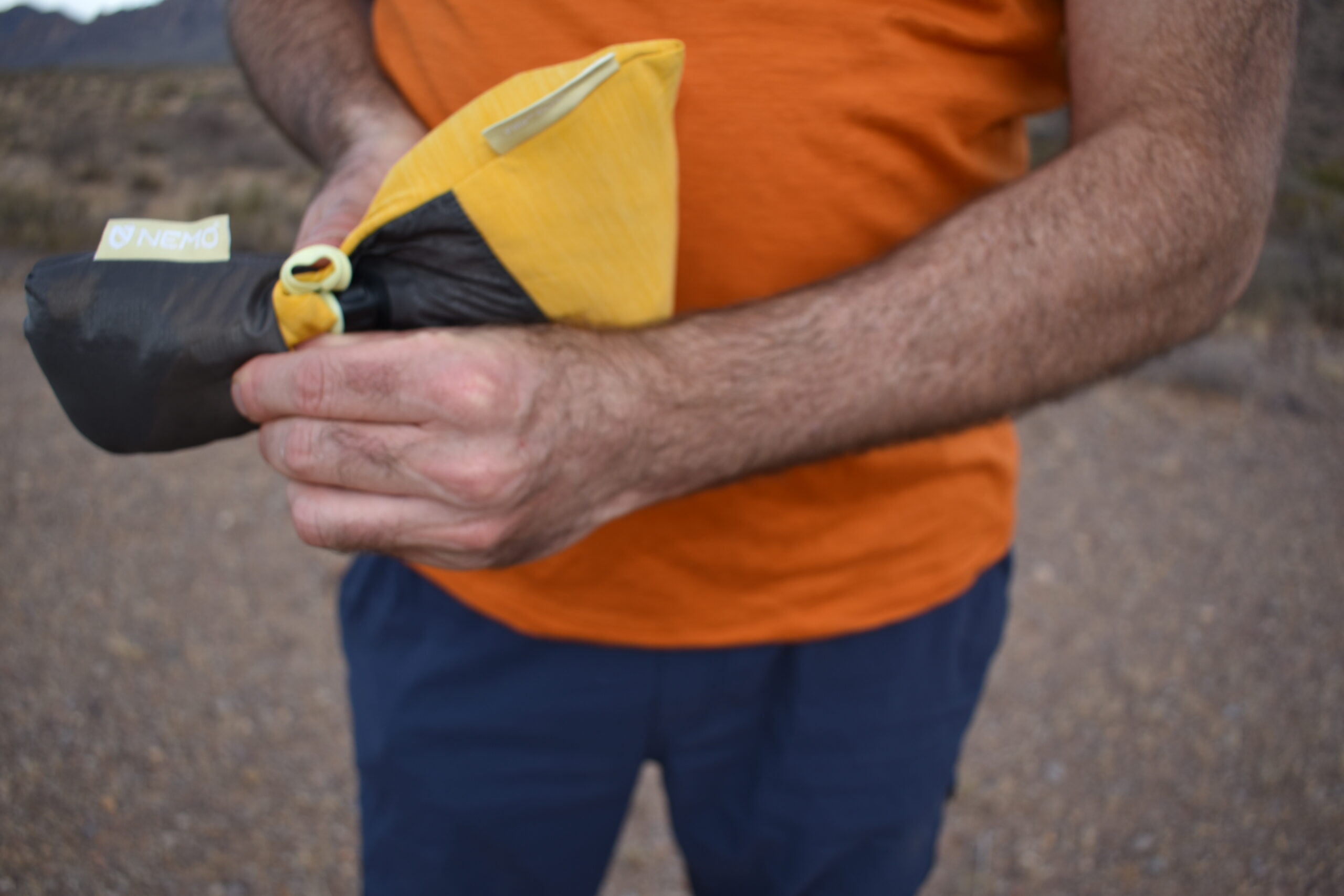 The author smashing the Elite Luxury Pillow into a small stuff sack