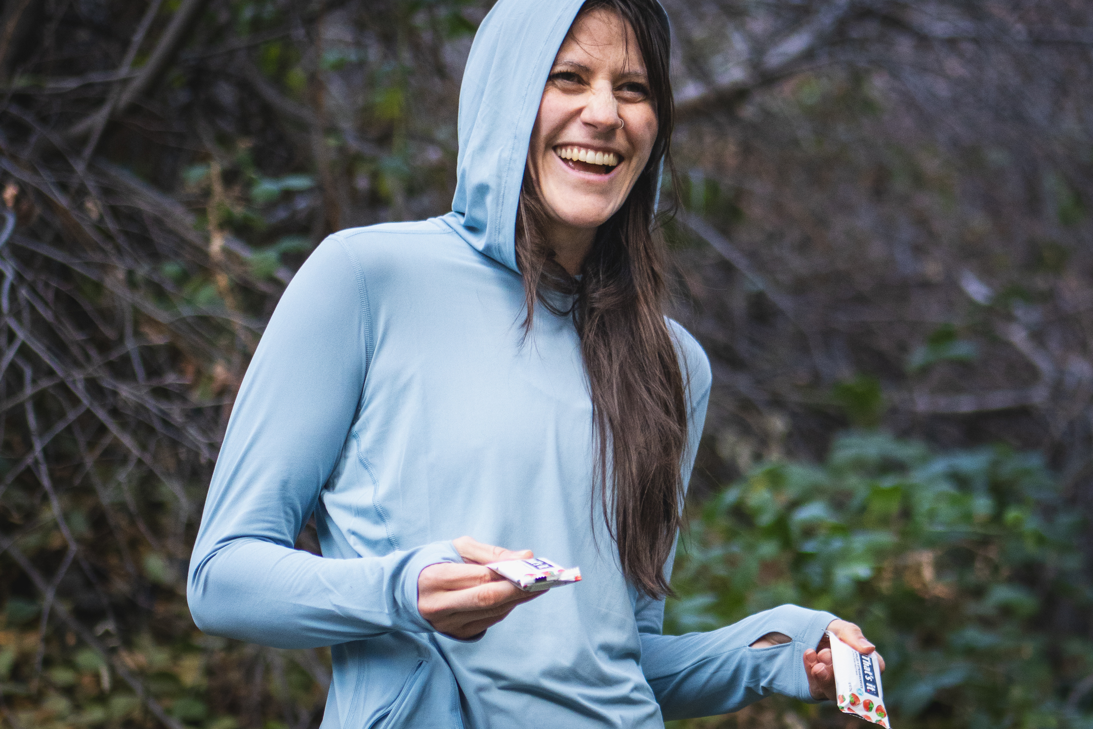 hiker laughing and handing out snacks