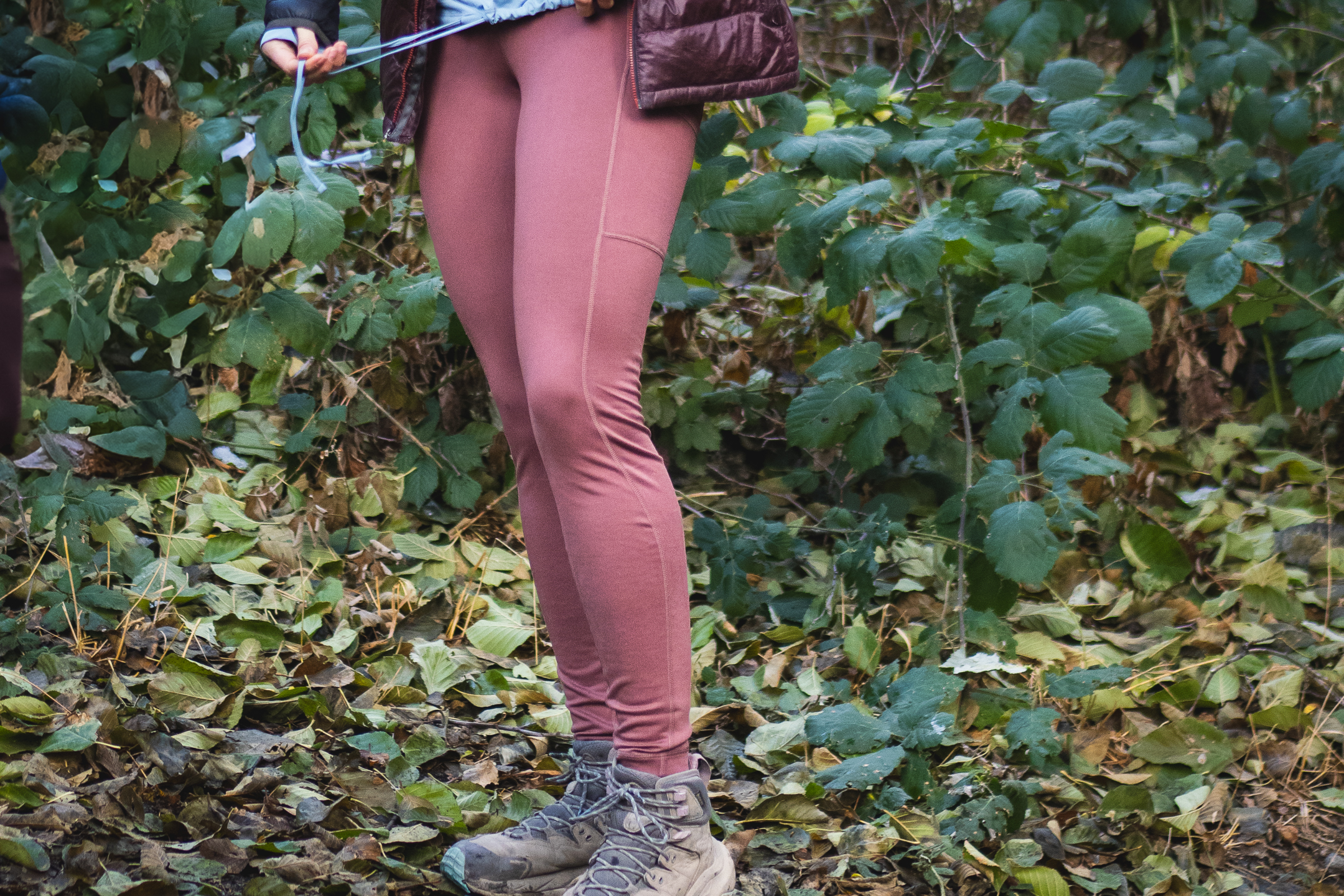 close up on bottom half of a person in pastel pink leggings