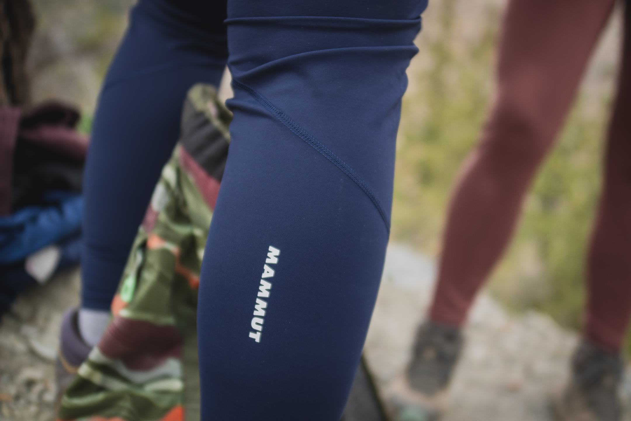 Woman hiking in dark blue athletic leggings.