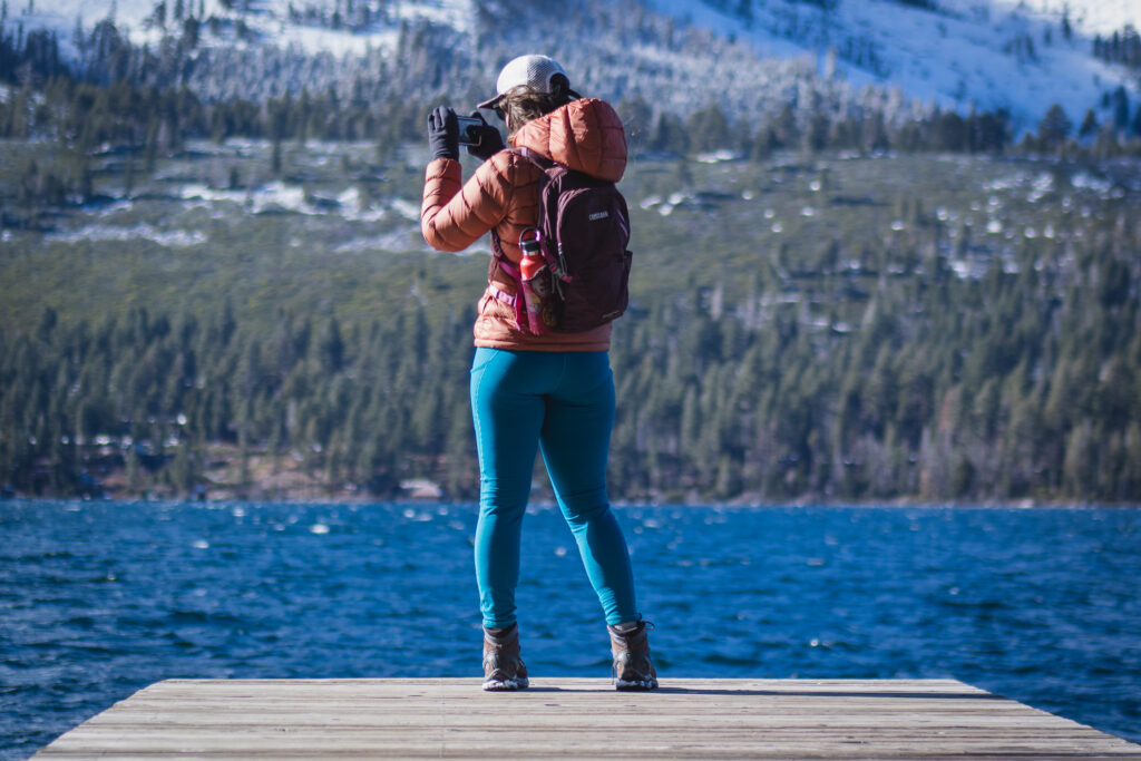 Woman hiking in bright blue leggings.