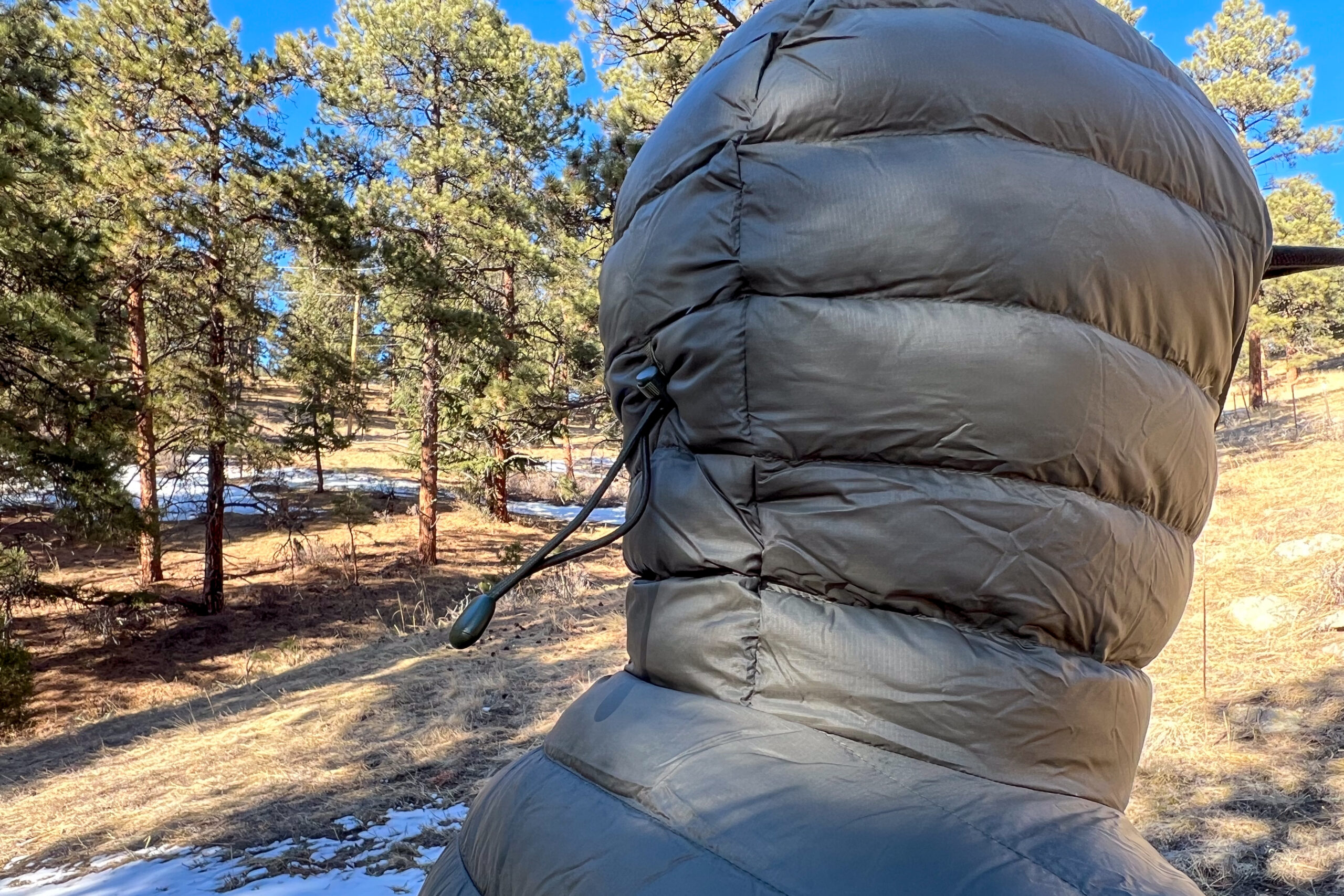 Side view of the Patagonia Down Sweater Hoody’s hood with a drawcord adjustment pulled tight.