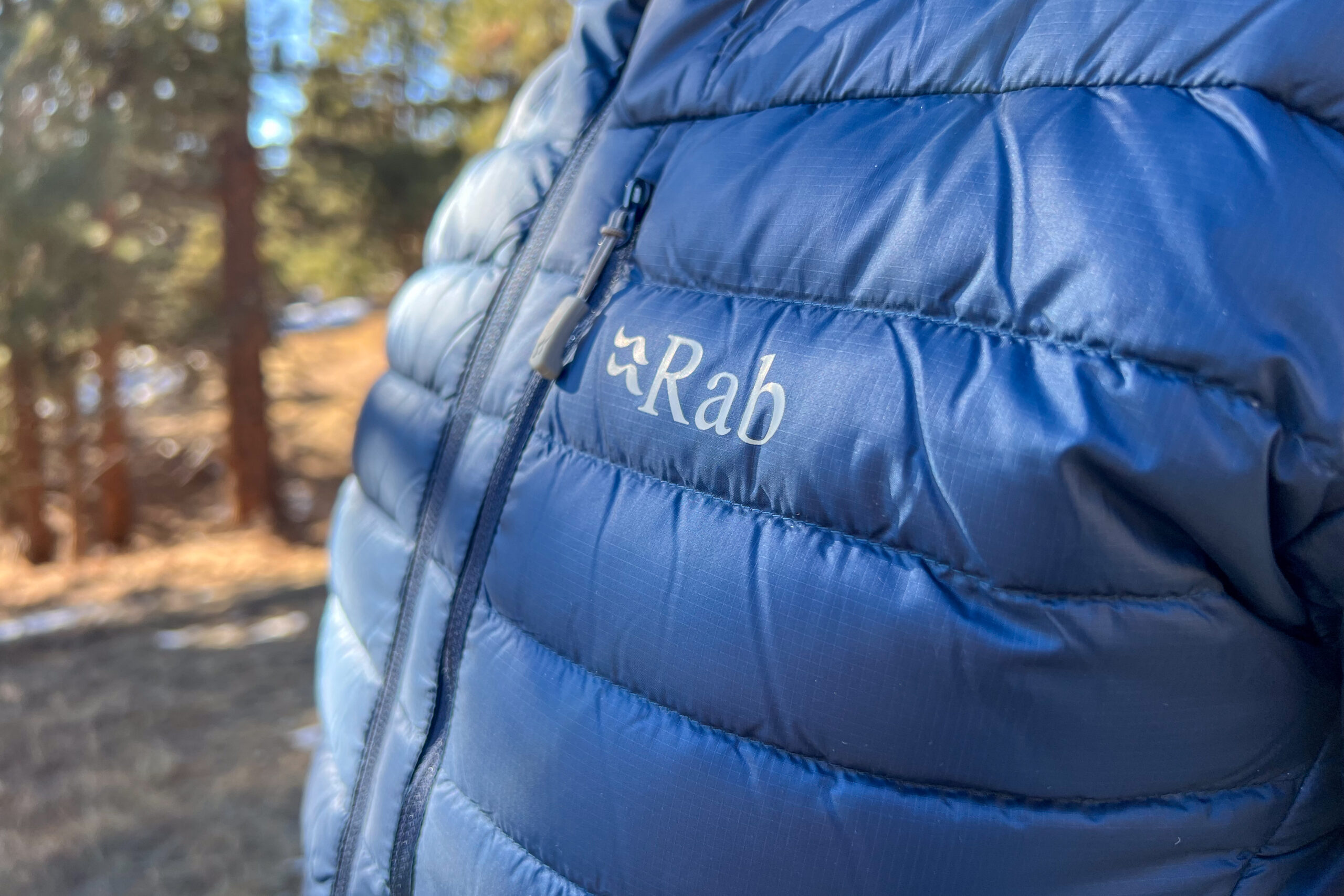 Close-up of the stitching and fabric on the Rab Microlight Alpine jacket, showing the durable, wind-resistant Pertex Quantum material.