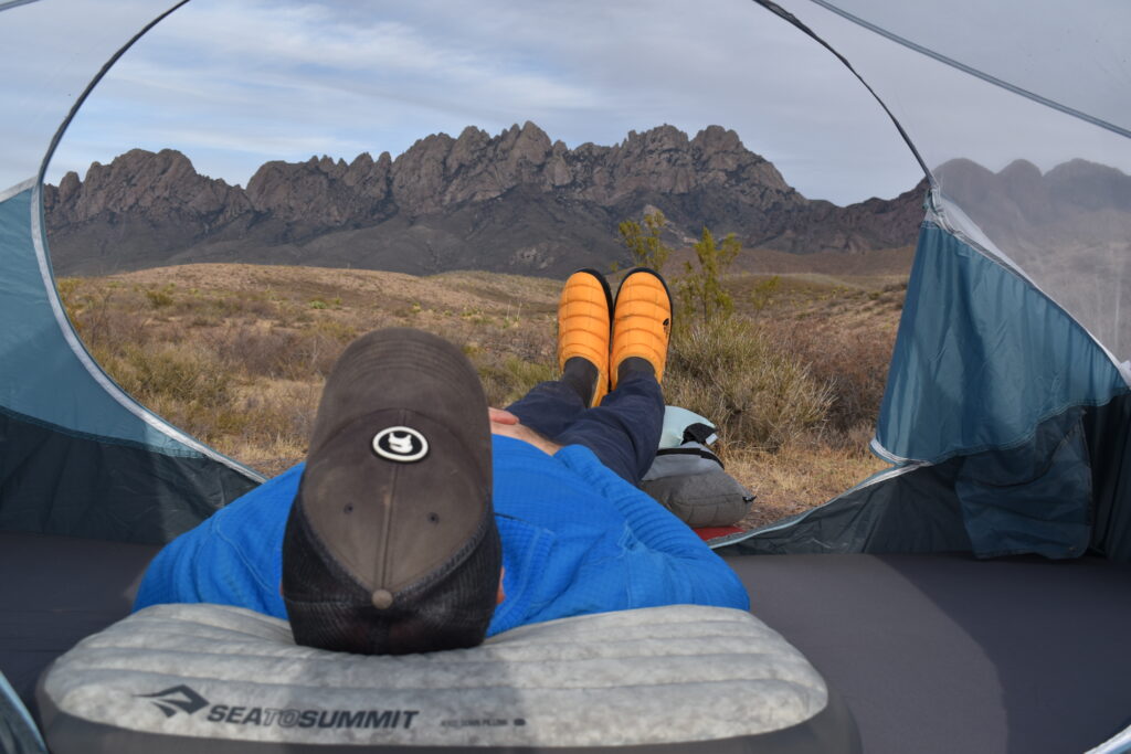 The author resting on the Sea to Summit Aeros Down Deluxe Pillow while staring at New Mexico's Organ Mountains