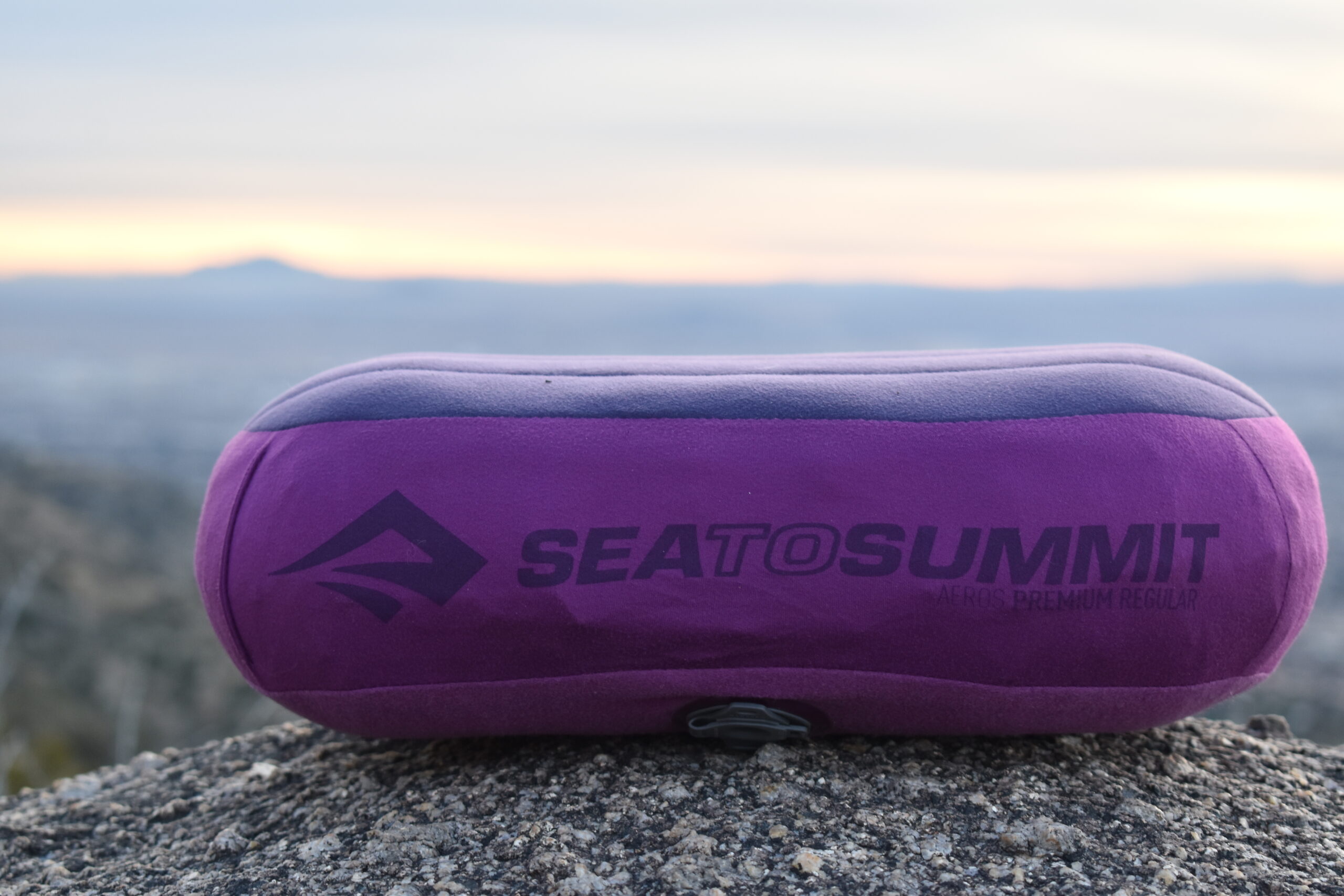 Close up of Aeros Premium Pillow on a boulder with the sunset in the background