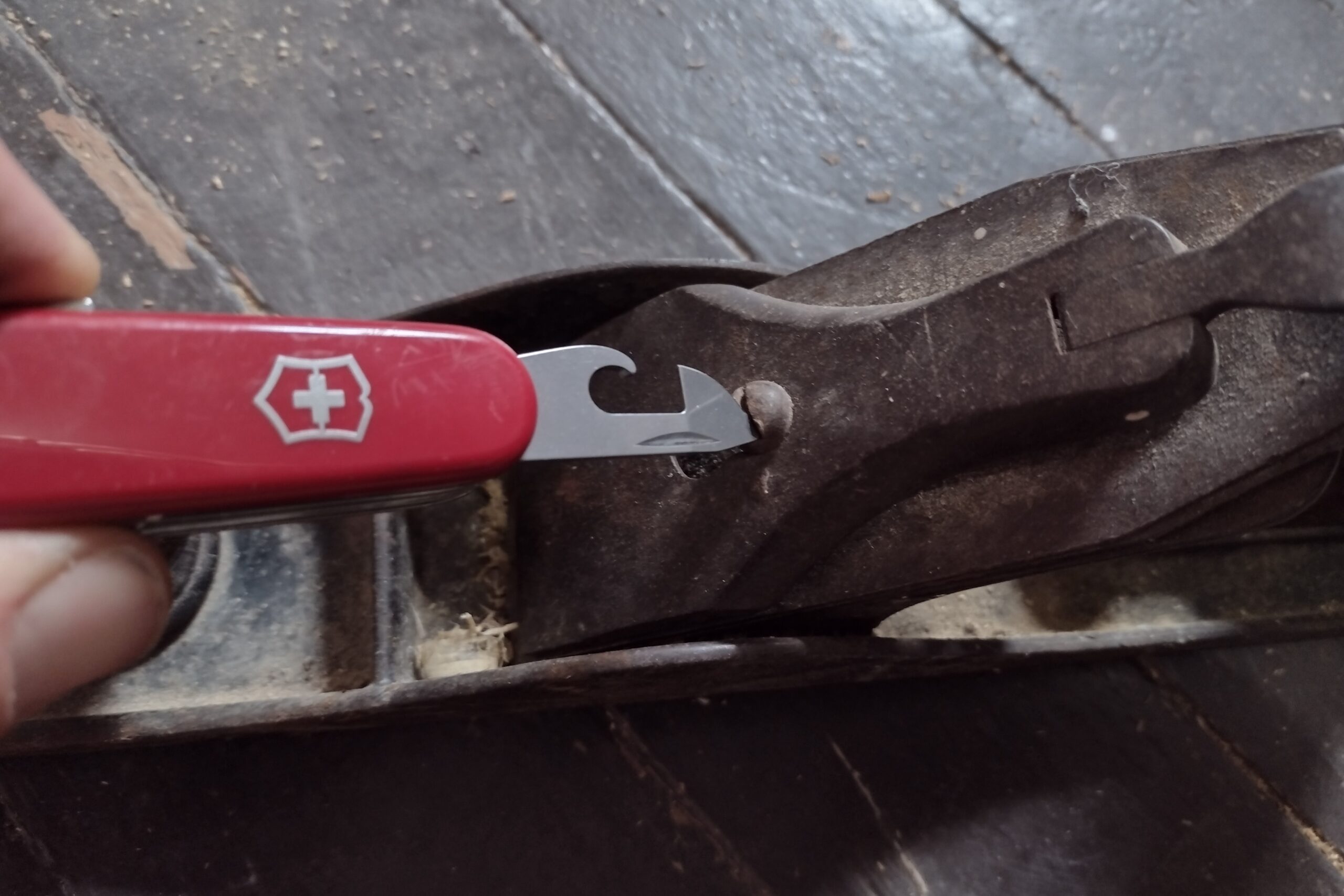 The Victorinox Huntsman adjusting a standard screw on a wood plane.