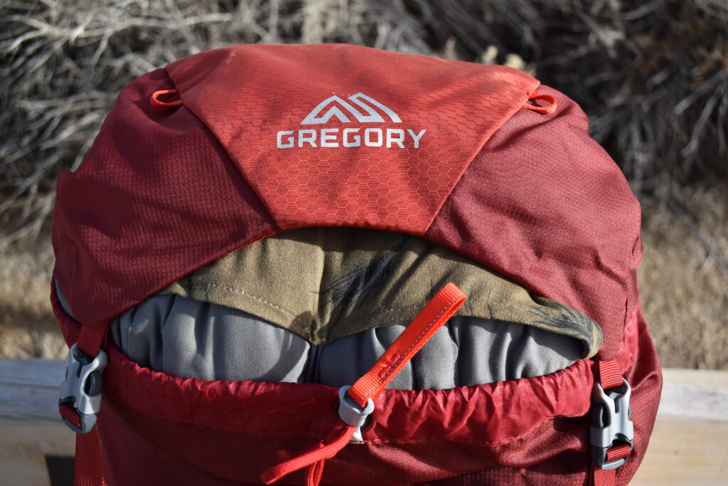 The Therm-a-rest Compressible pillow fills the entire opening of a 50L backpack