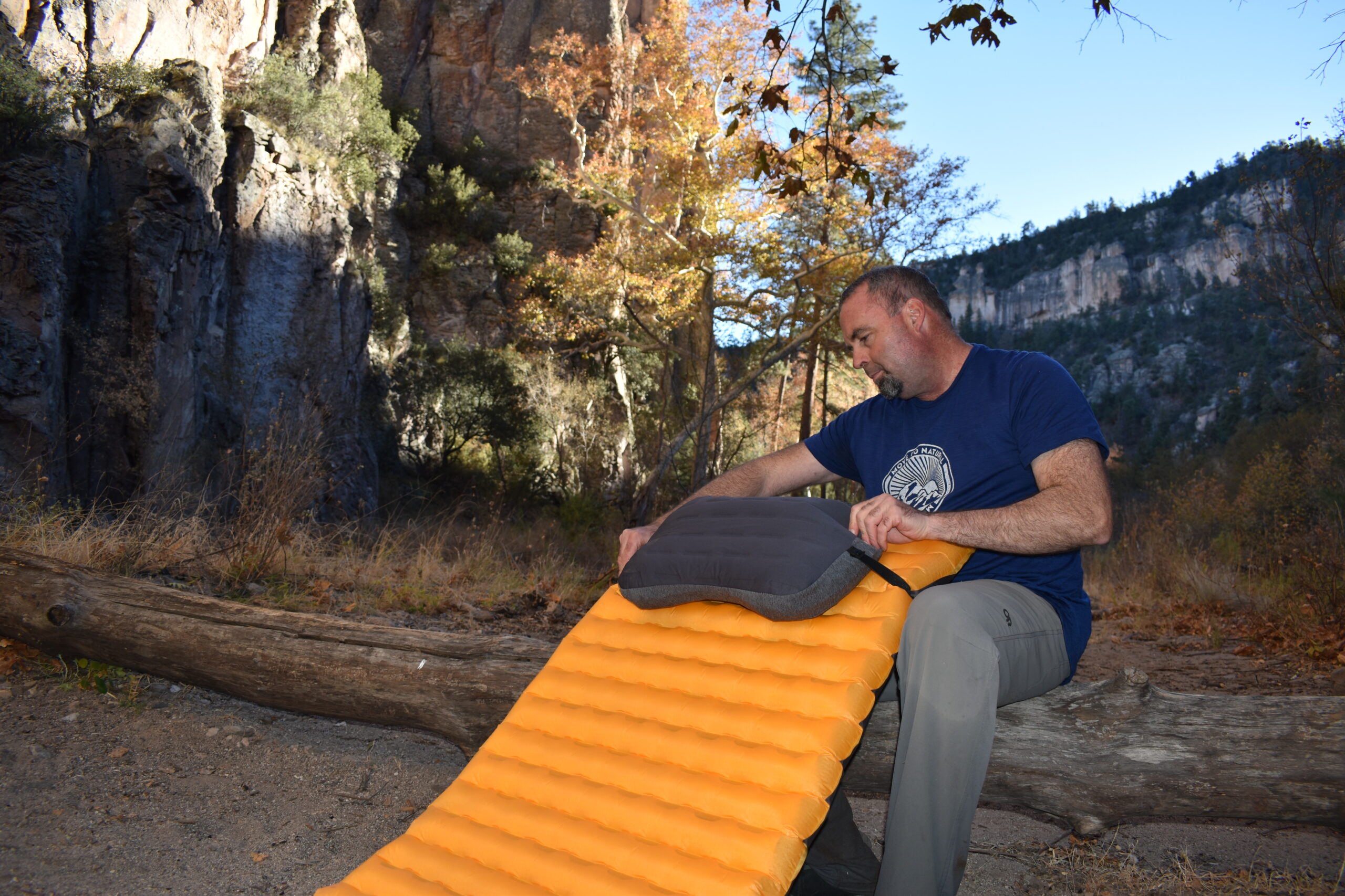 The author secures the Trekology Aluft Pro to his sleeping pad using the pillow's convenient strap