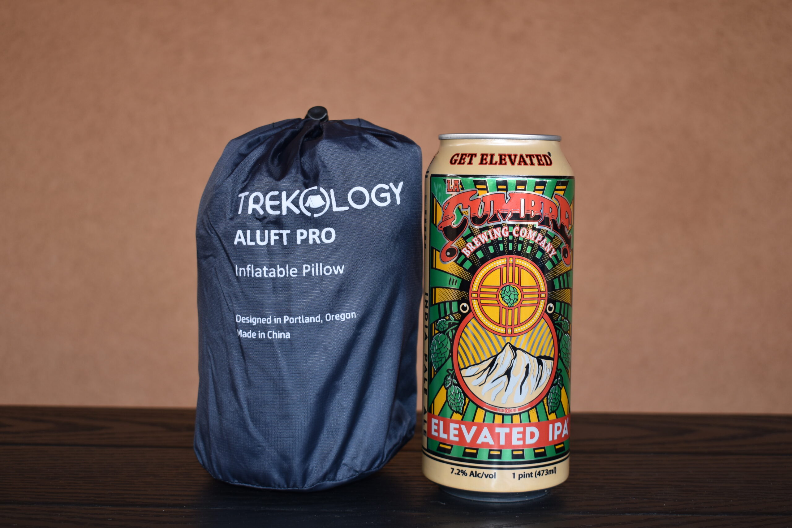 Packed Trekology Aluft Pro pillow placed next to a similarly sized 20 oz can of craft beer