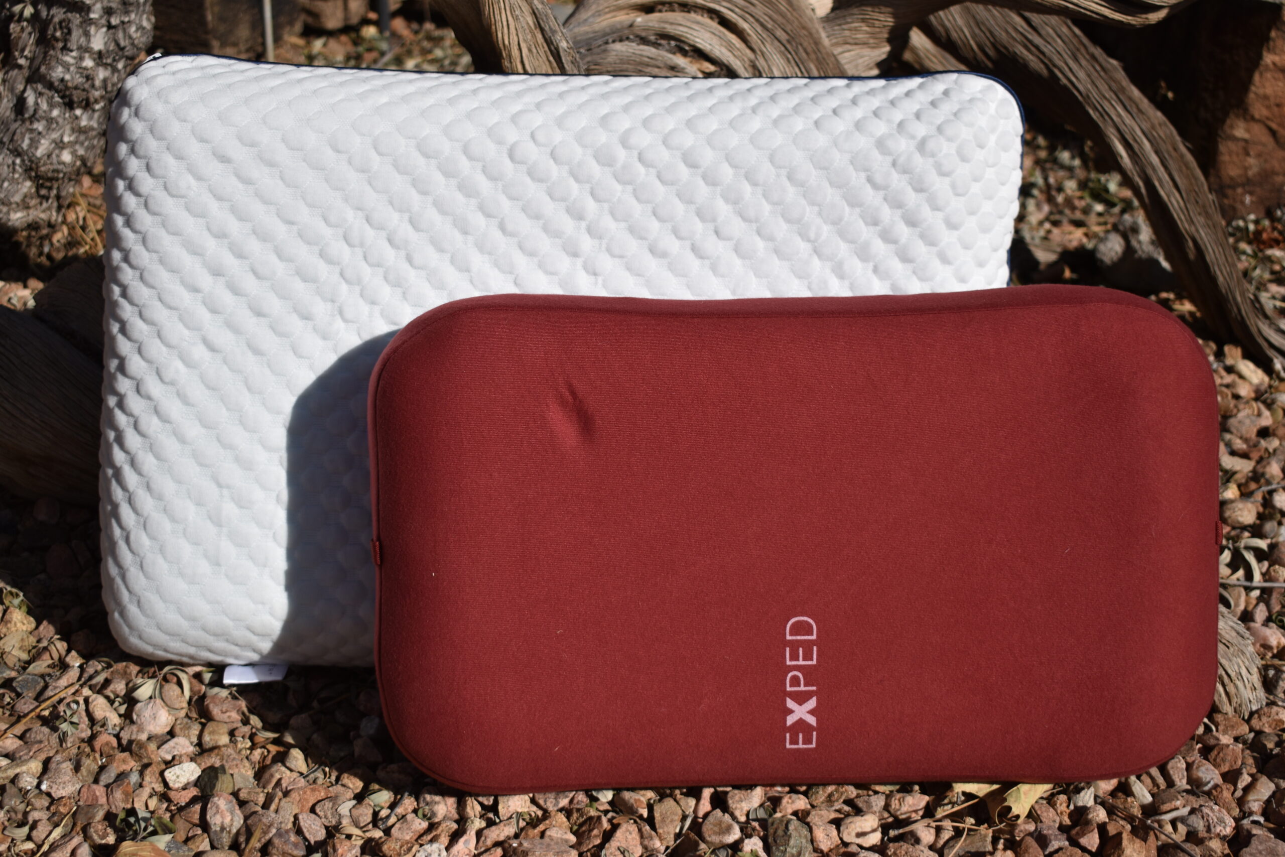 The Exped Mega Pillow rests against the larger Weekender Gel Memory Foam to compare their sizes