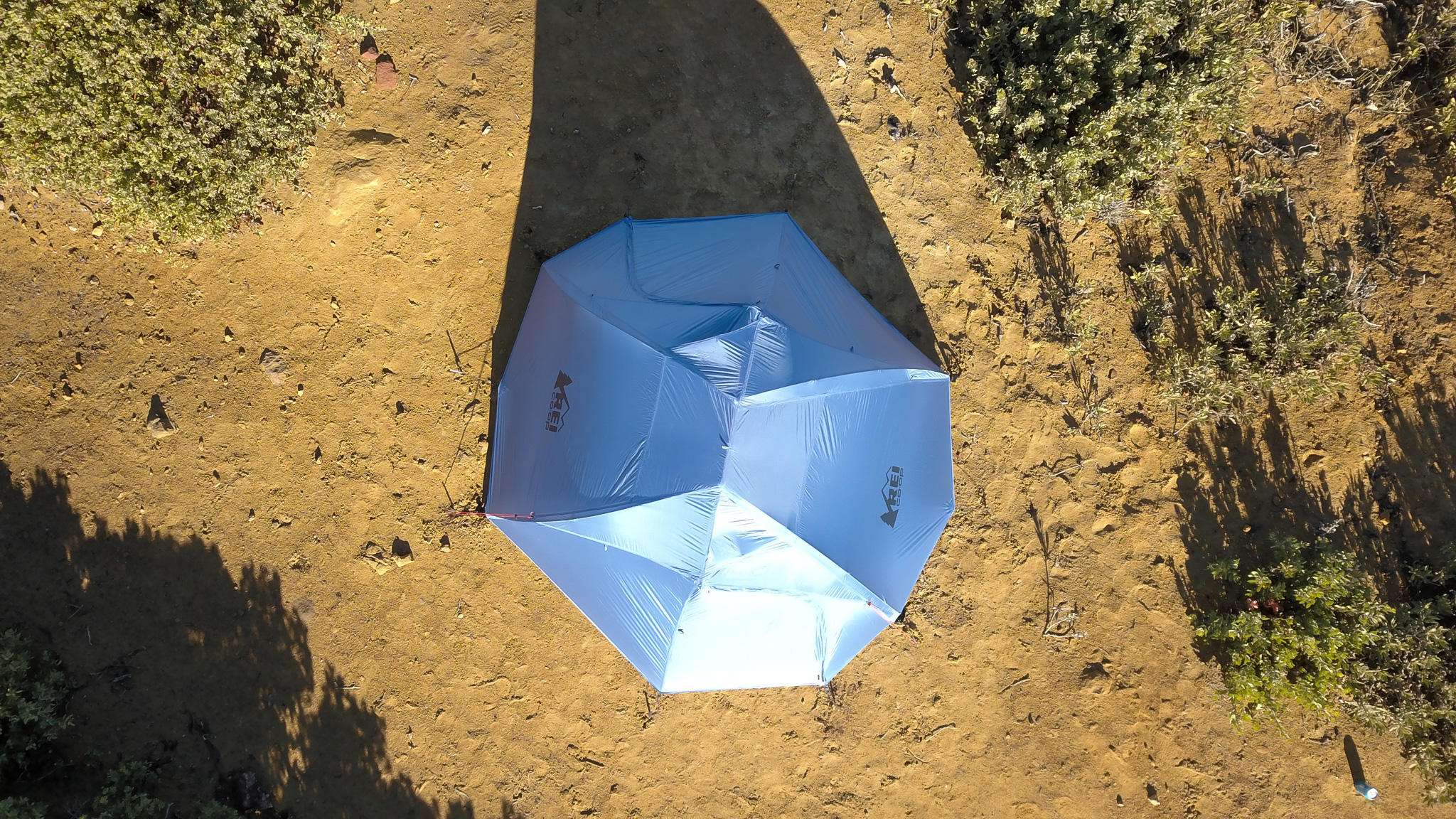 Direct overhead view of the REI Half Dome SL2+ showing the full footprint area with the rainfly fully deployed and staked out.