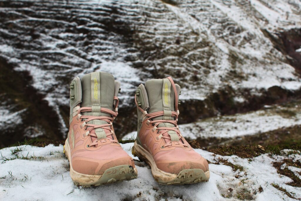 Pair of Women’s Altra Lone Peak ALL-WTHR 2 hiking boots on a snowy hillside