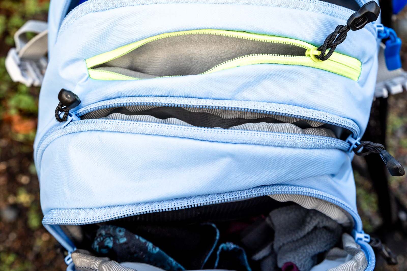 Details of M.U.L.E.® 12 Hydration Pack 100 oz - a view of the compartments of the pack from the top with all the zippers open 