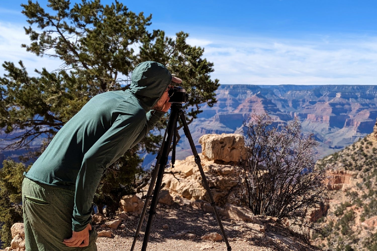 A man takes a photo from an overlook at the Grand Canyon