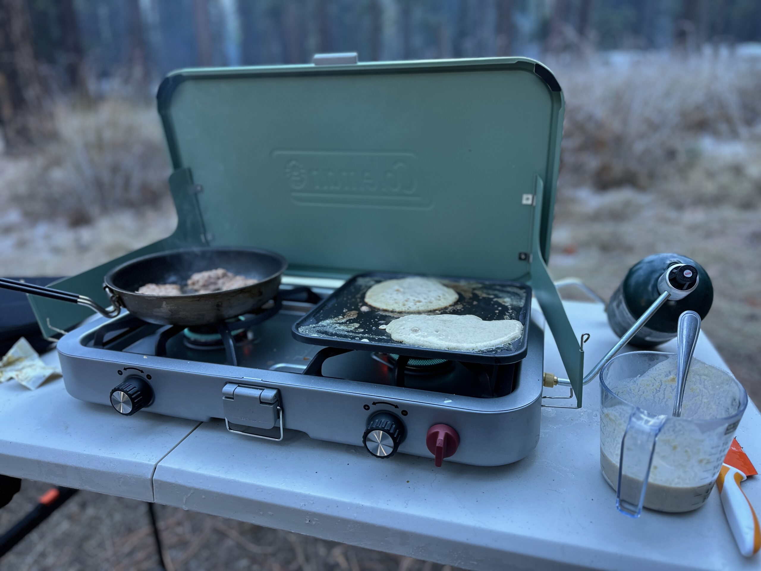 Close up of flap jacks being made on the flat top grill attachment of the Coleman Cascade 3-in-1 Camp Stove