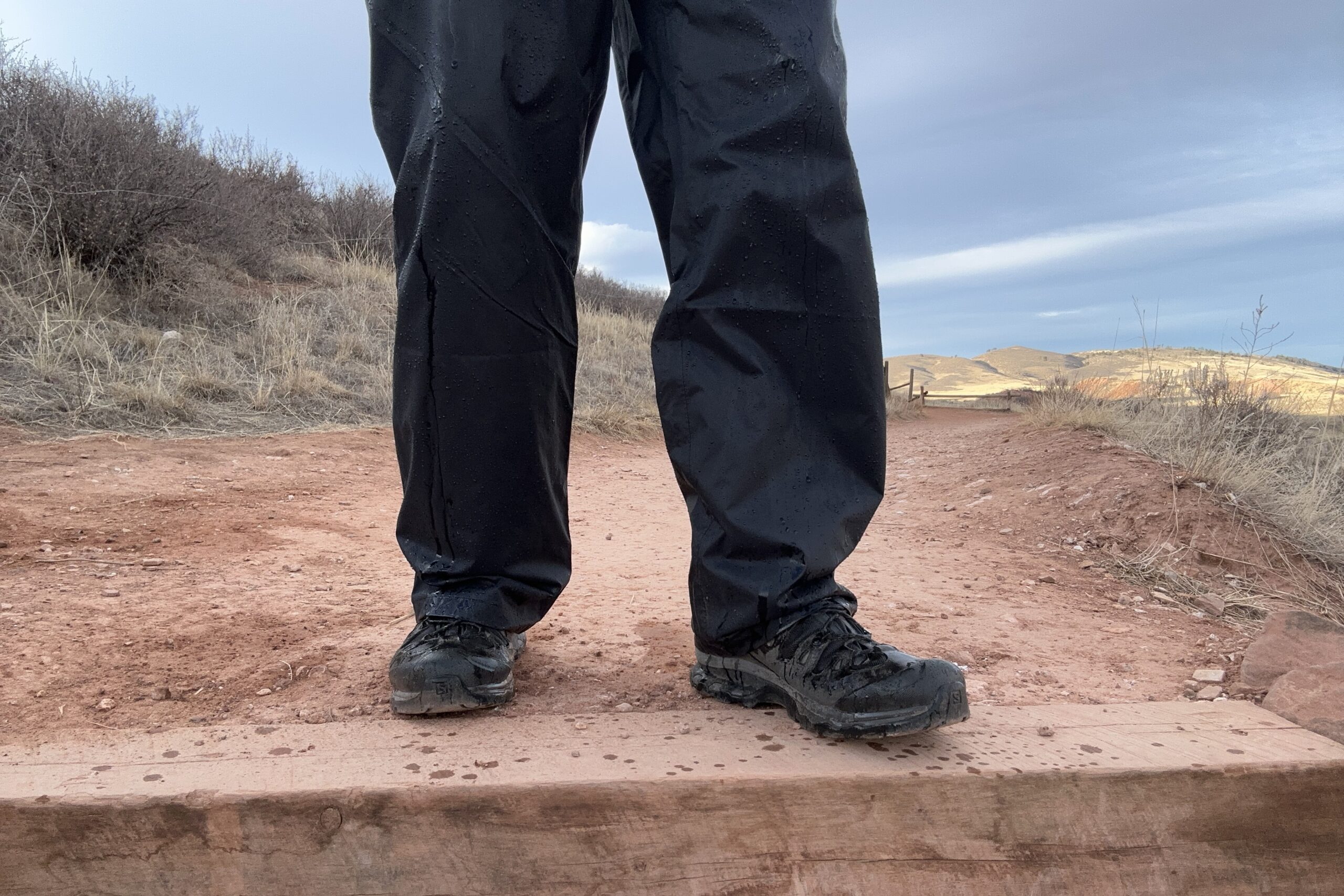 Image of someone wearing the black Columbia Rebel Roamer II on a trail.