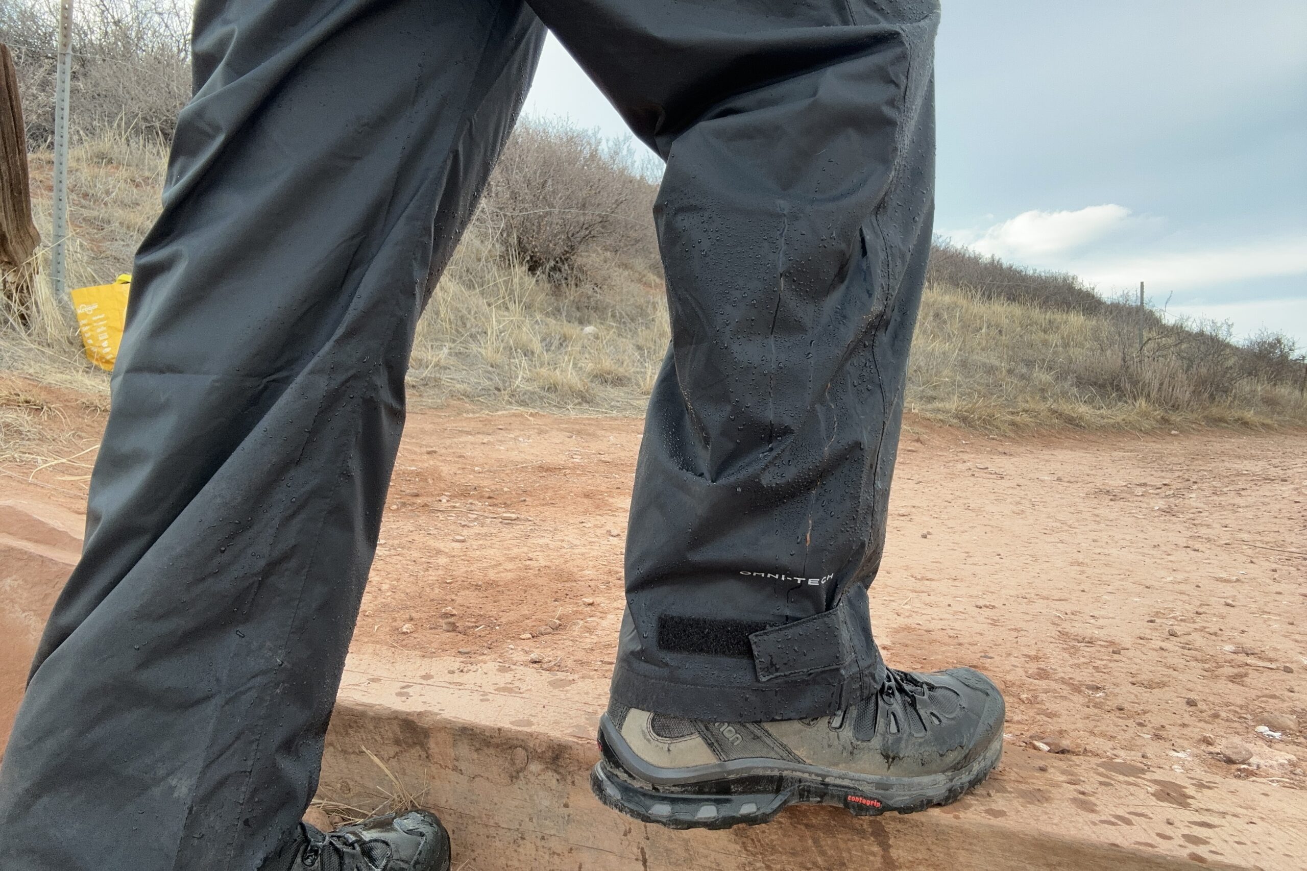 Image of someone wearing the black Columbia Rebel Roamer II on a trail.