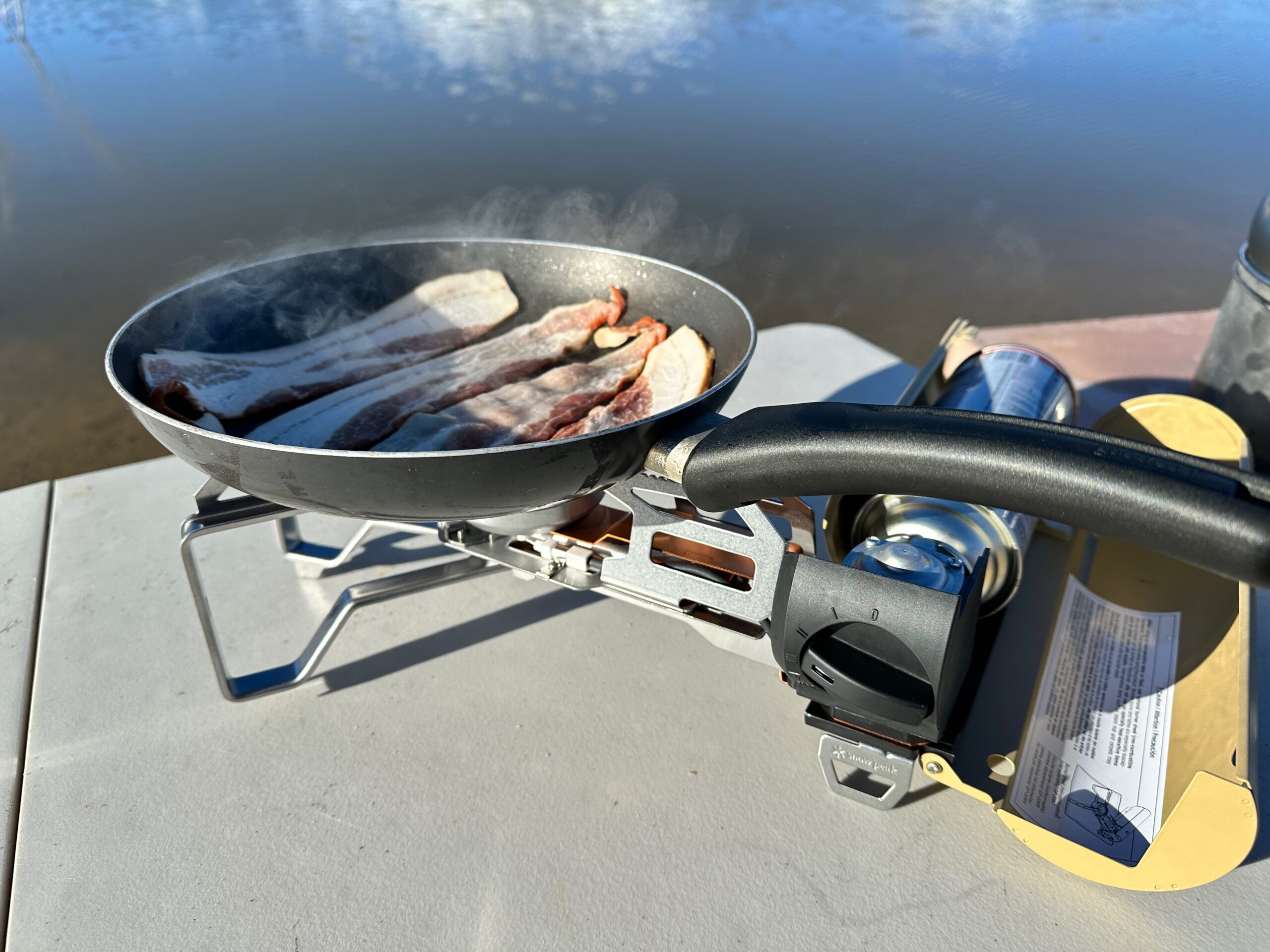 bacon cooking on the Snow Peak Home & Camp butane stove