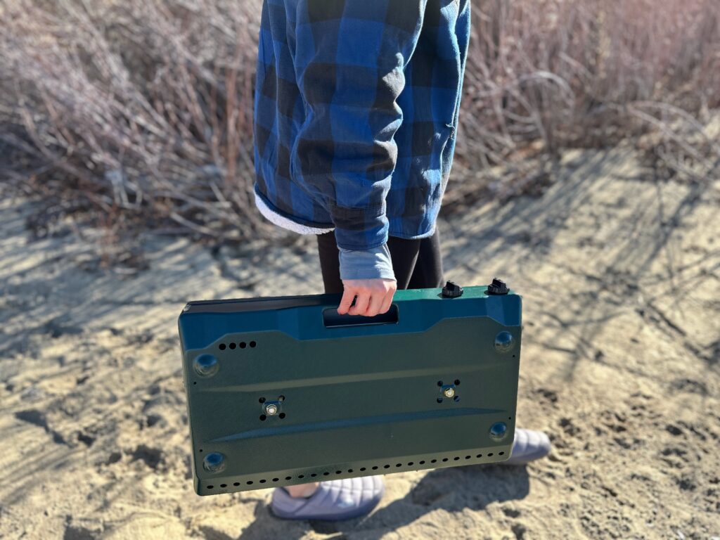 the Coleman Cascade Classic 2-Burner cooking camp meals at a beachside camp