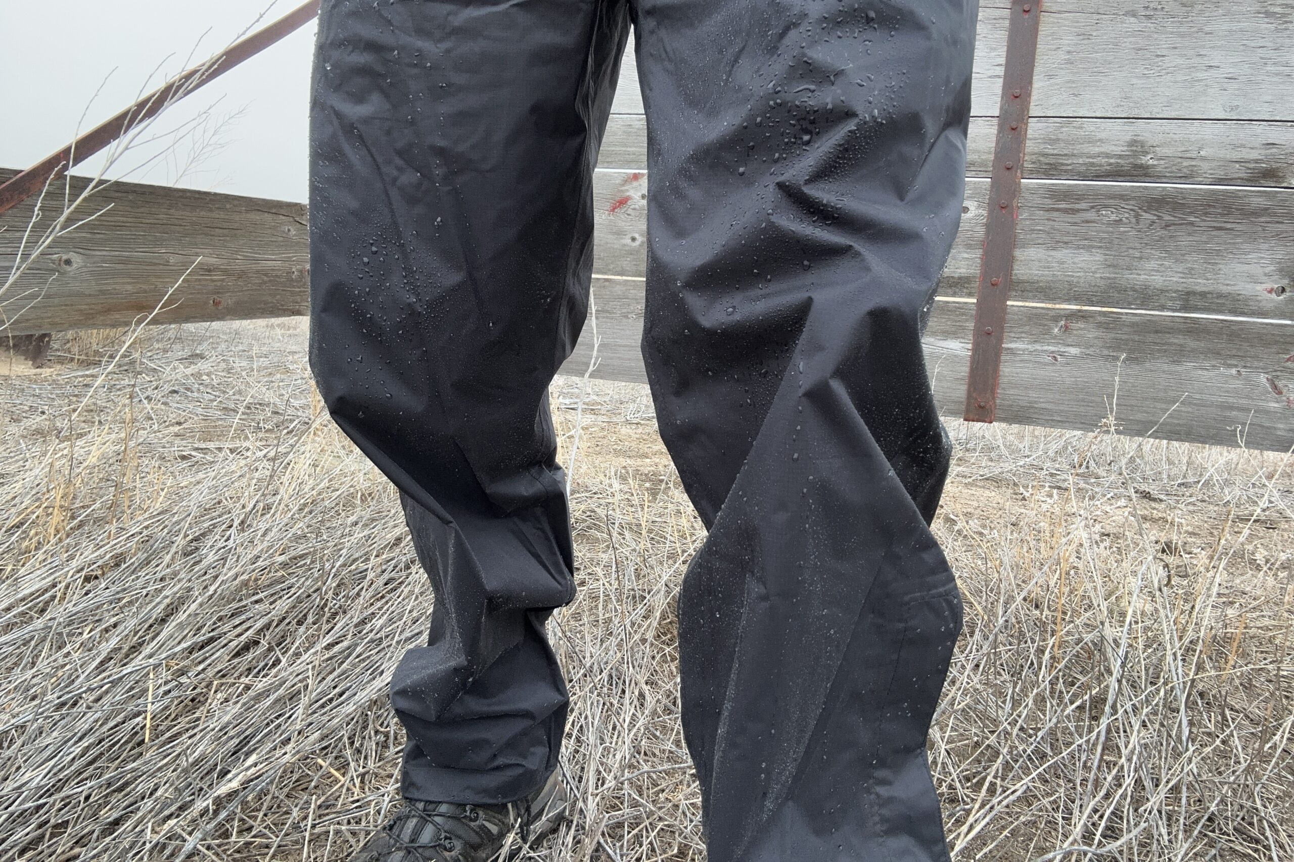 Closeup of someone wearing the black Marmot PreCip Eco rain pants.